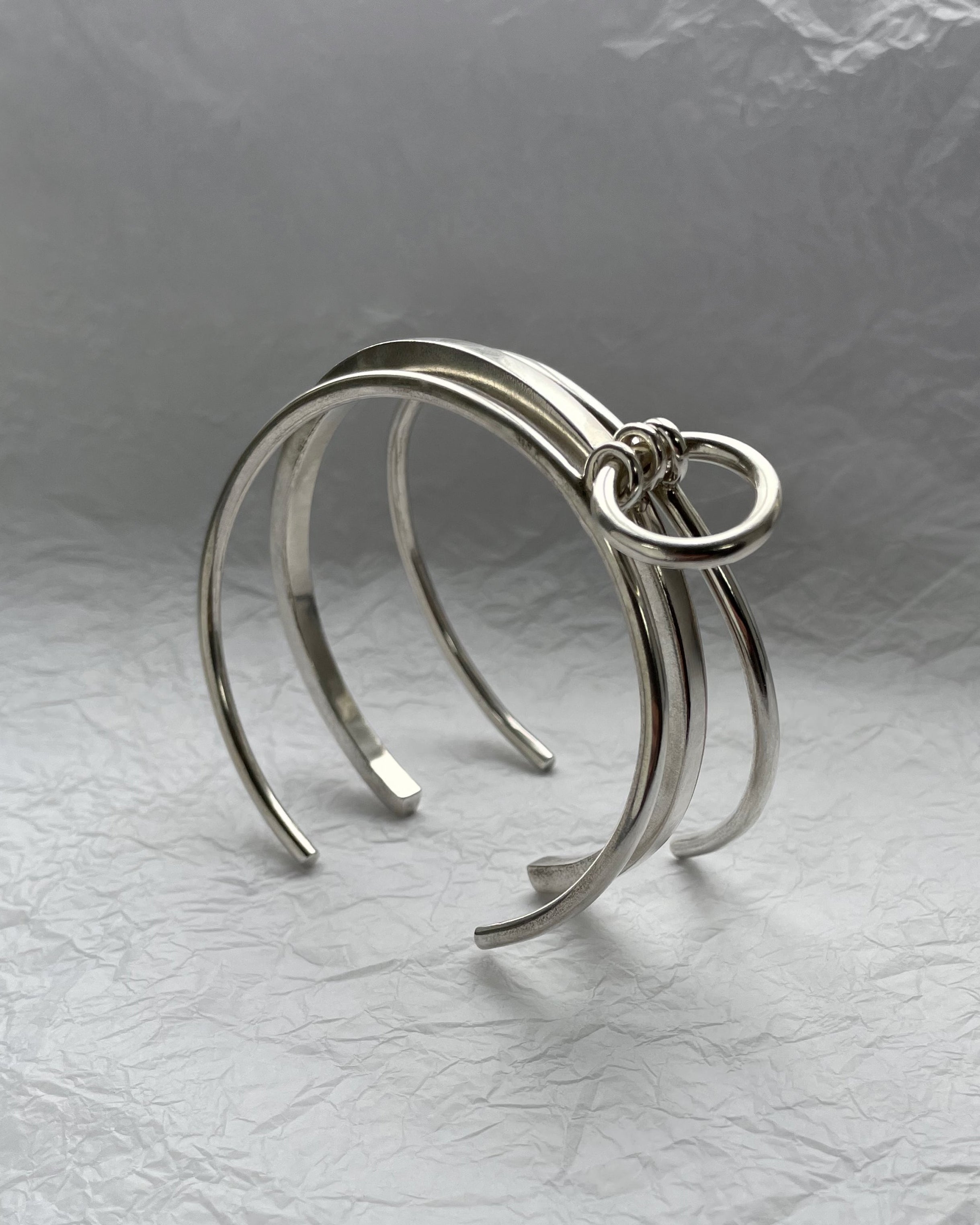 side view of 1990s tri-torque bangle in sterling silver with three connected forms and sculptural design – Auric Vintage