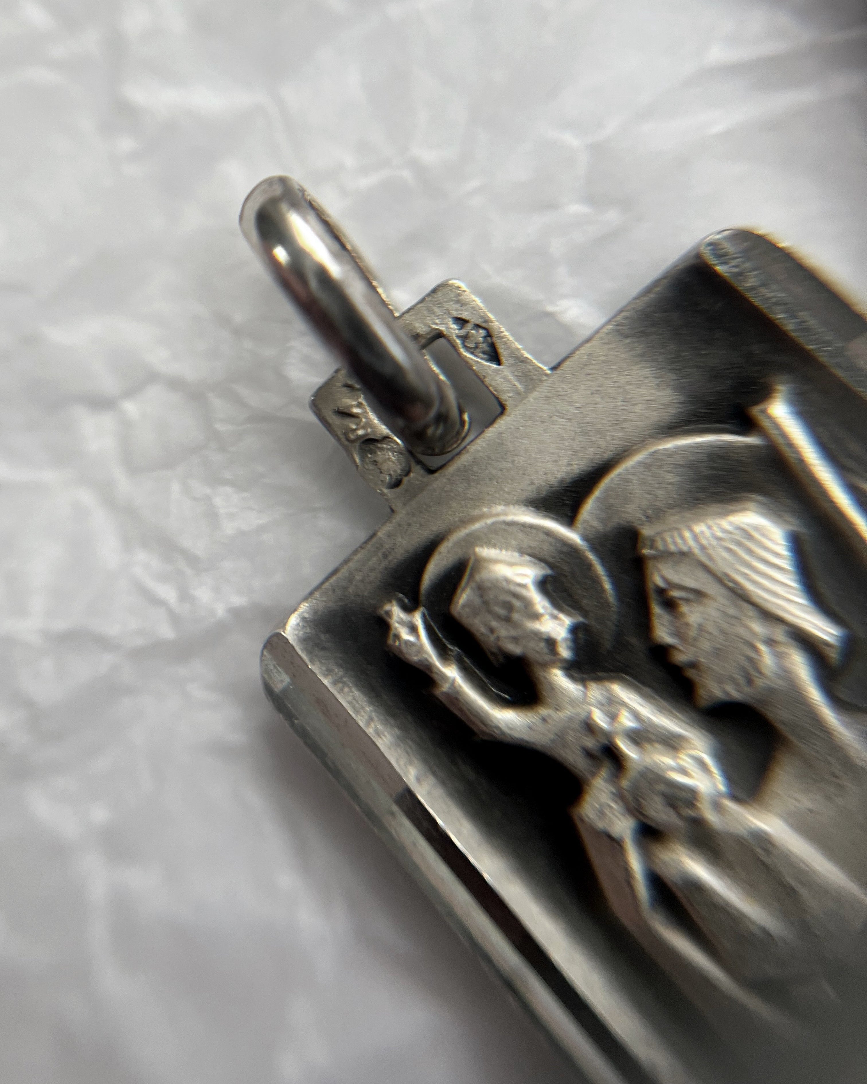 Close-up of mid century French 800 silver St. Christopher pendant showing crab hallmark and Jean Balme maker’s mark – Auric Vintage