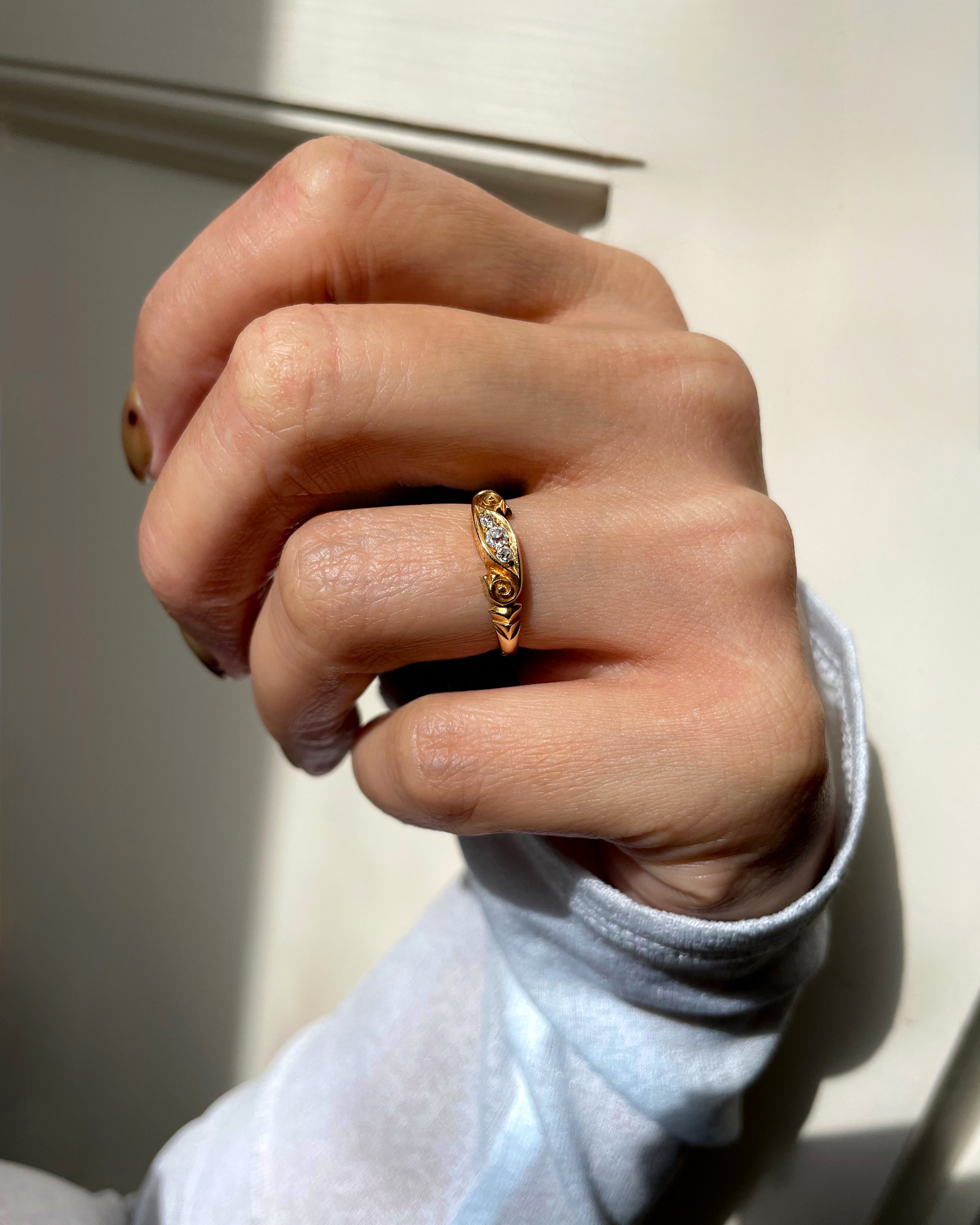 Victorian diamond three stone banner ring in 18kt yellow gold worn on hand showing scale and carved detail – Auric Vintage