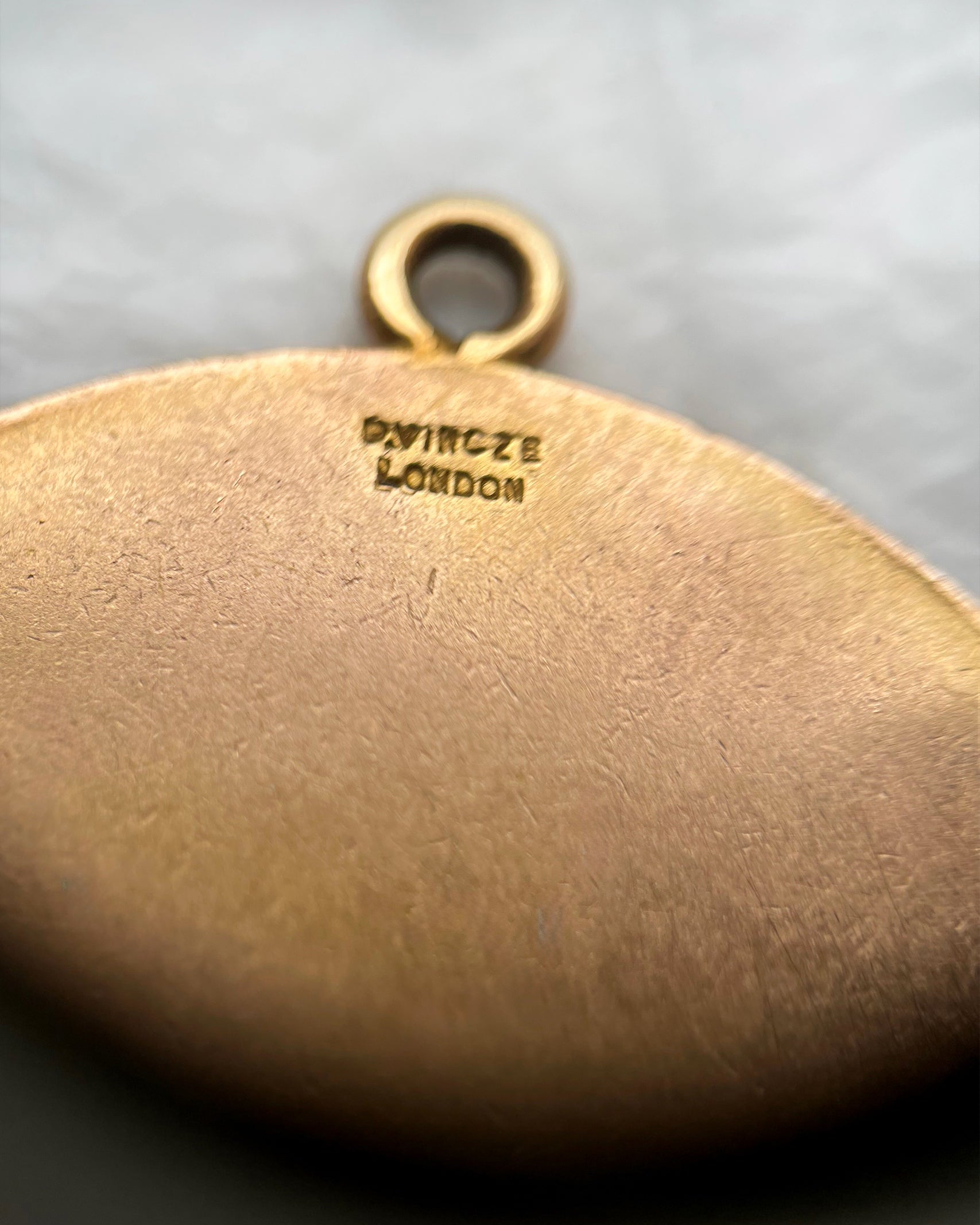 Close-up of vintage 9kt gold St. Christopher medal showing Paul Vincze London signature – Auric Vintage