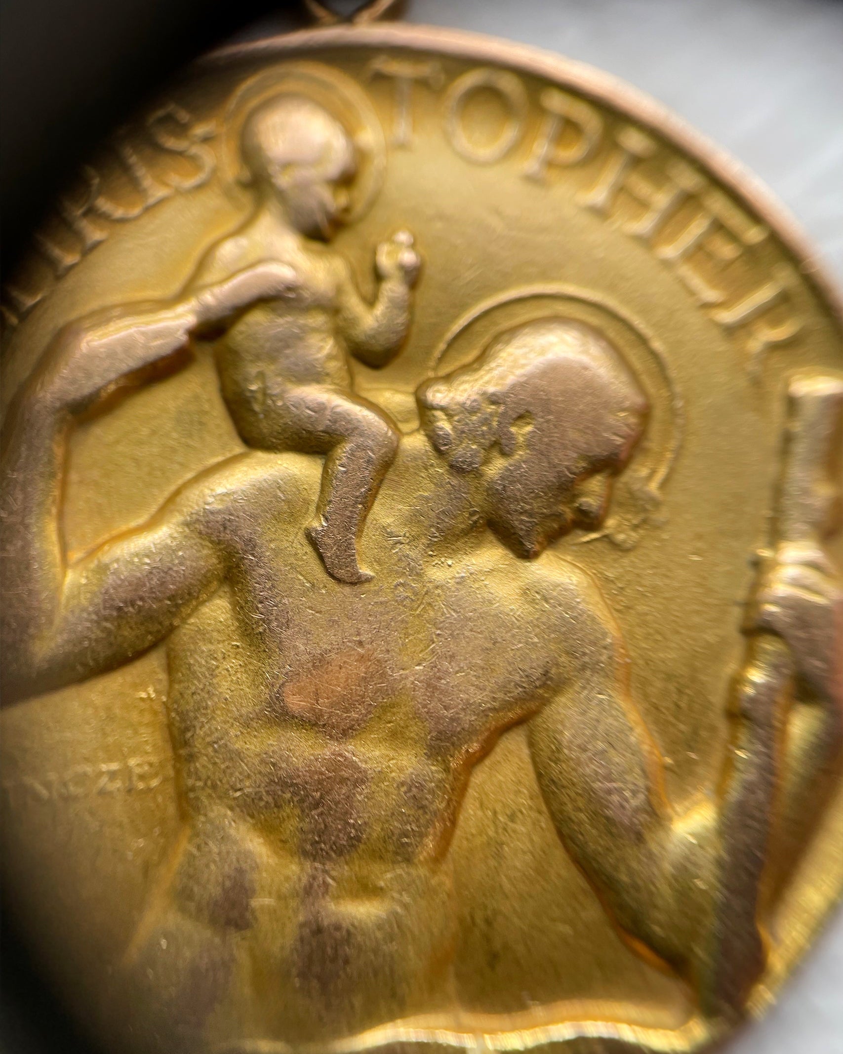 Close-up of vintage 9kt gold St. Christopher medal showing saint and child relief detail – Auric Vintage