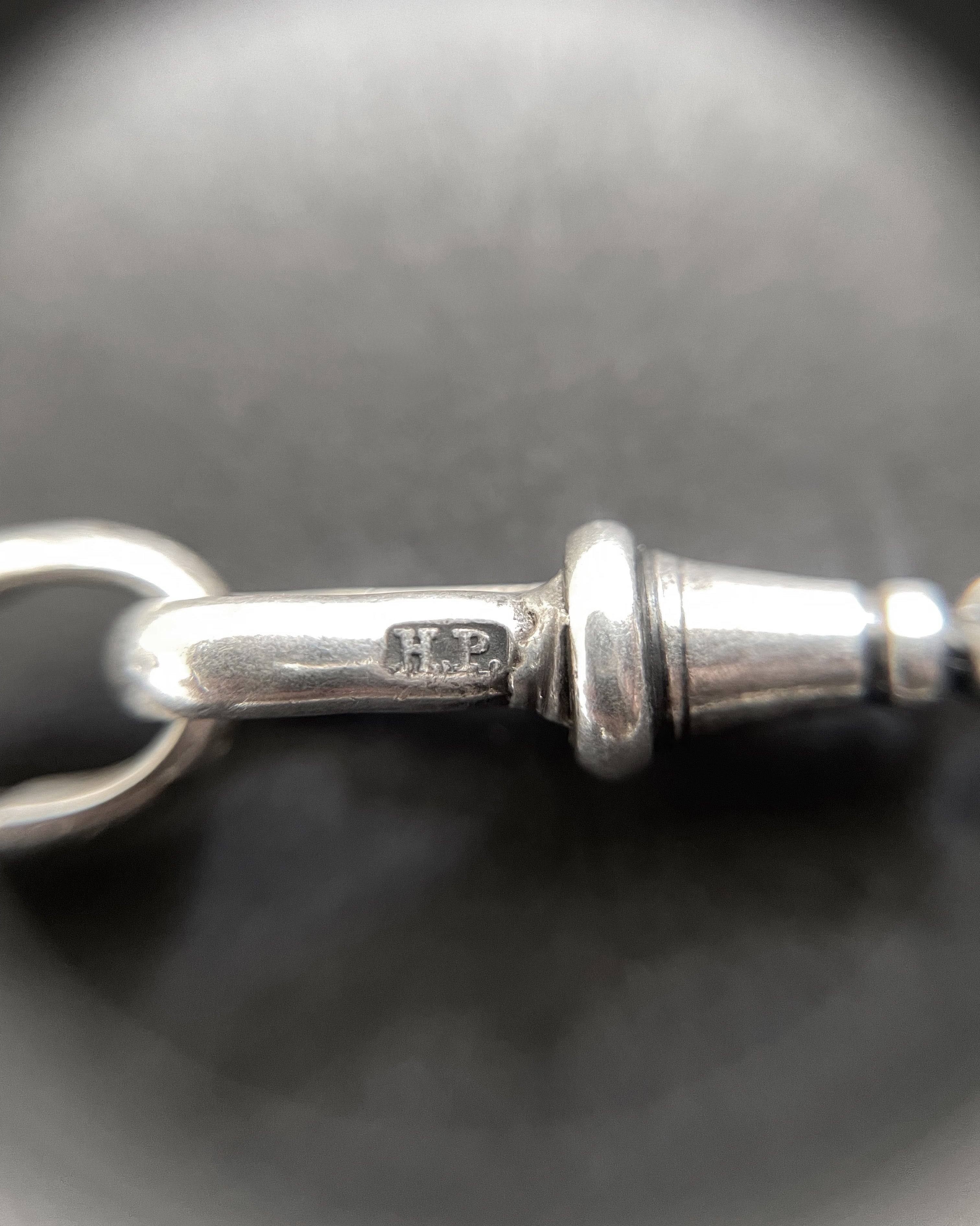Close-up of Edwardian sterling silver chain clasp showing Henry Pope maker’s mark – Auric Vintage
