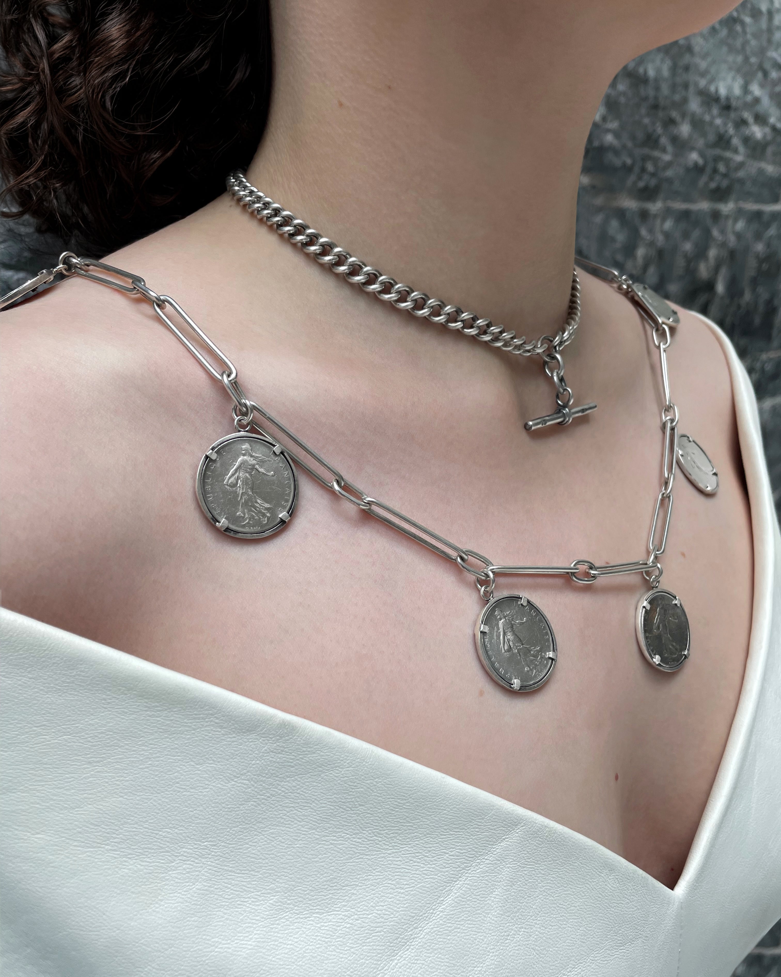 Arthus Bertrand 1 Franc coin sautoir in sterling silver layered on neck with silver T-bar chain – Auric Vintage