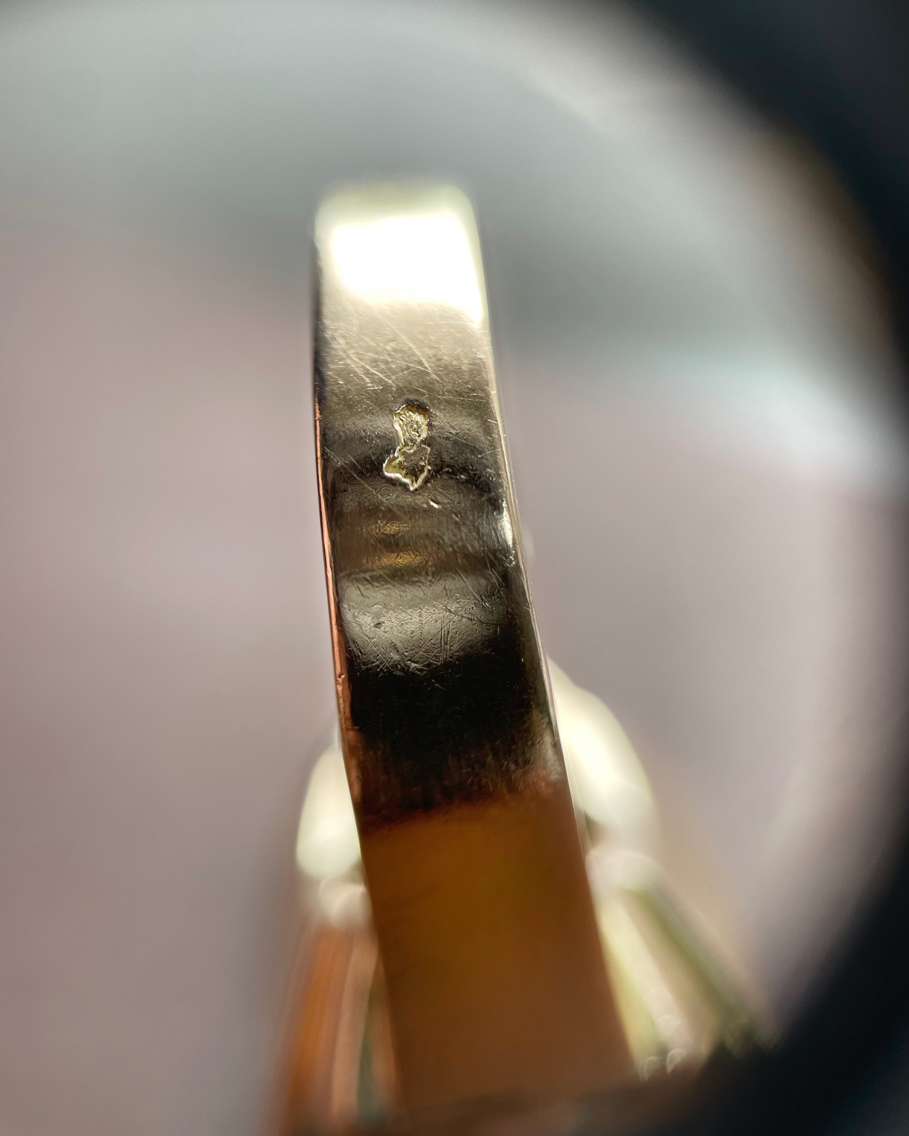 Close-up of retro French diamond ring showing eagle’s head and dog’s head hallmarks for gold and platinum – Auric Vintage