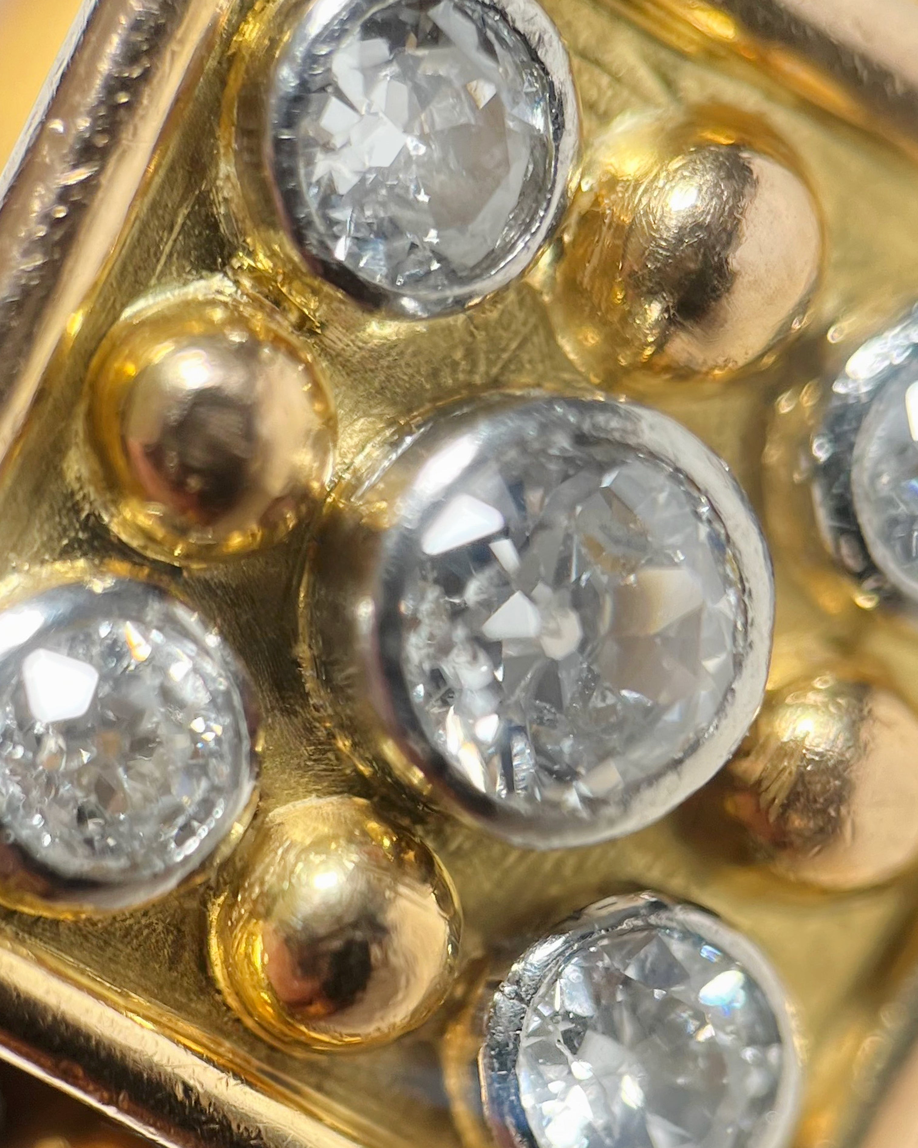 Close-up of retro French diamond ring showing old-cut diamonds in platinum rubover settings – Auric Vintage