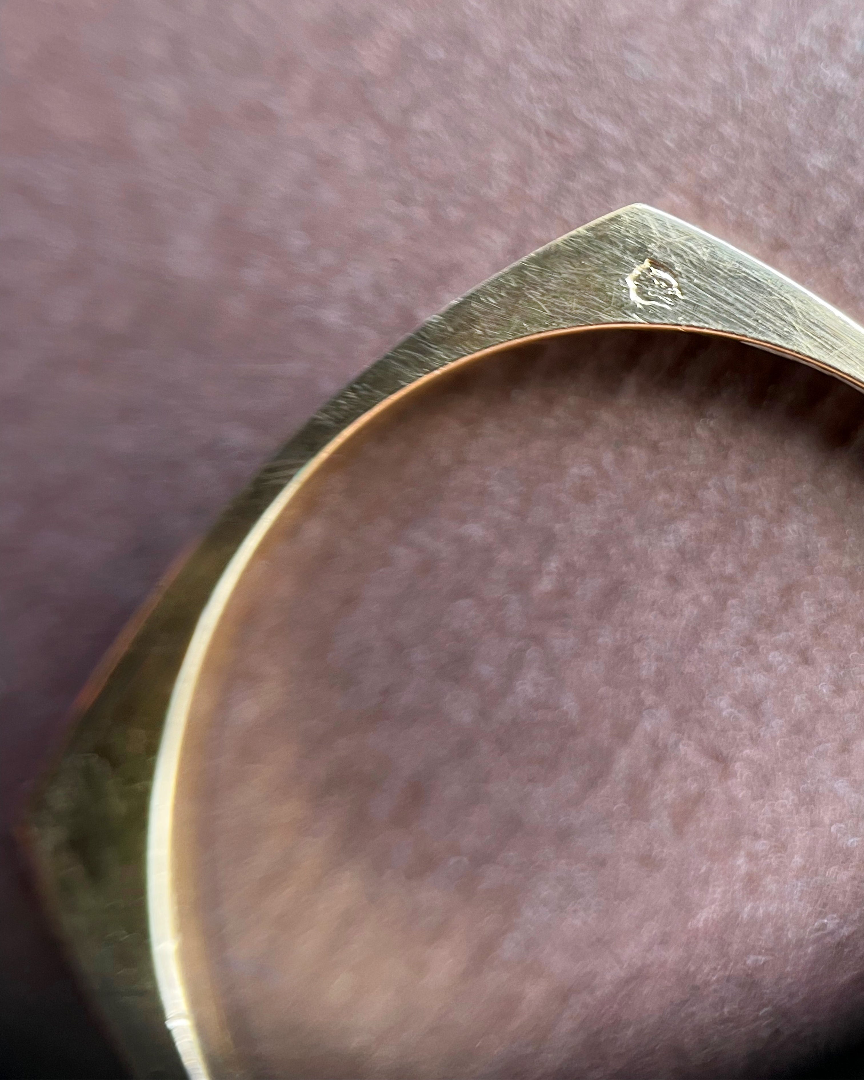 Close-up of French 18kt yellow gold ribbed band showing eagle’s head hallmark and maker’s mark – Auric Vintage