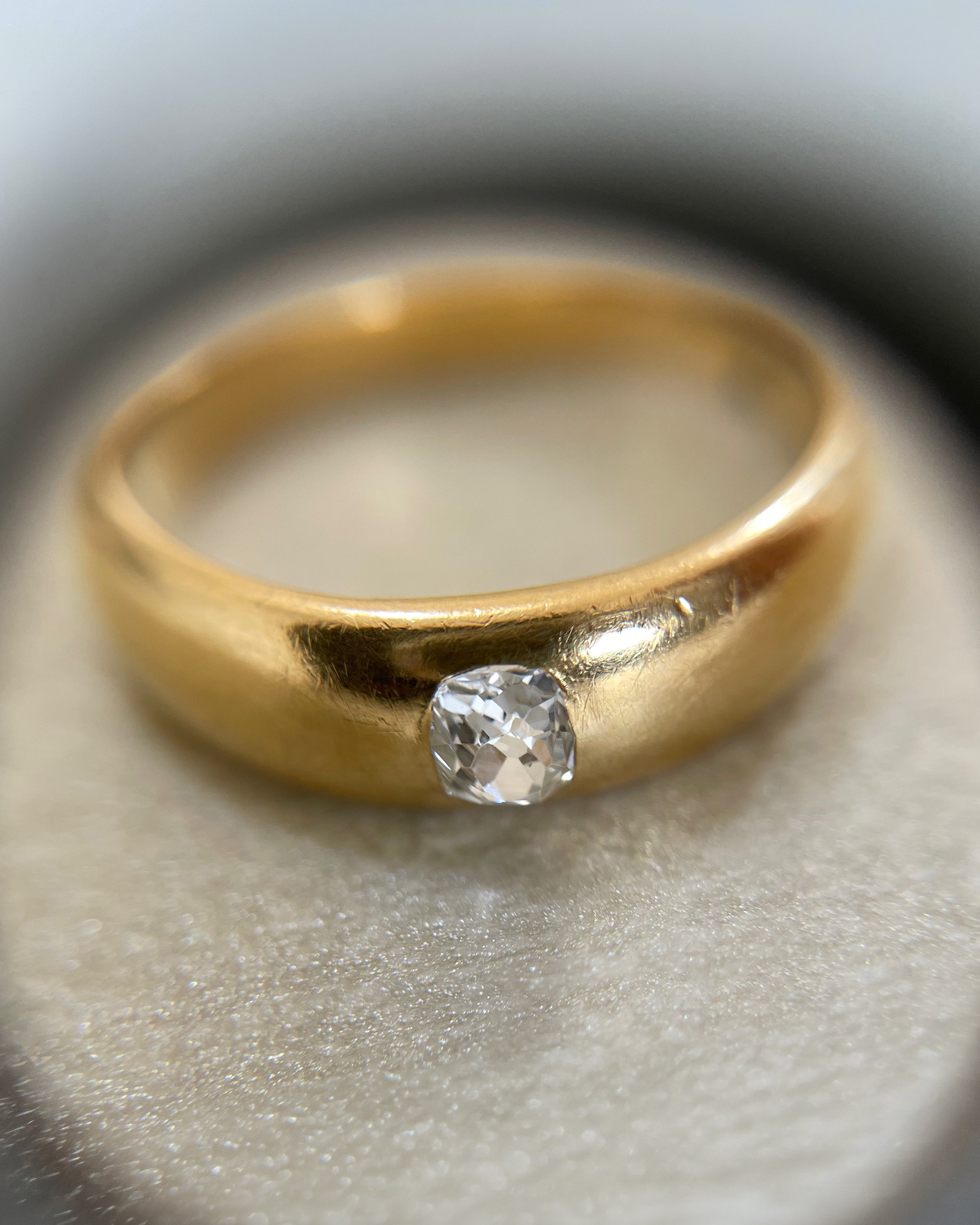 Close-up of Victorian solitaire diamond ring in 18kt yellow gold showing old mine cut diamond in flush setting – Auric Vintage