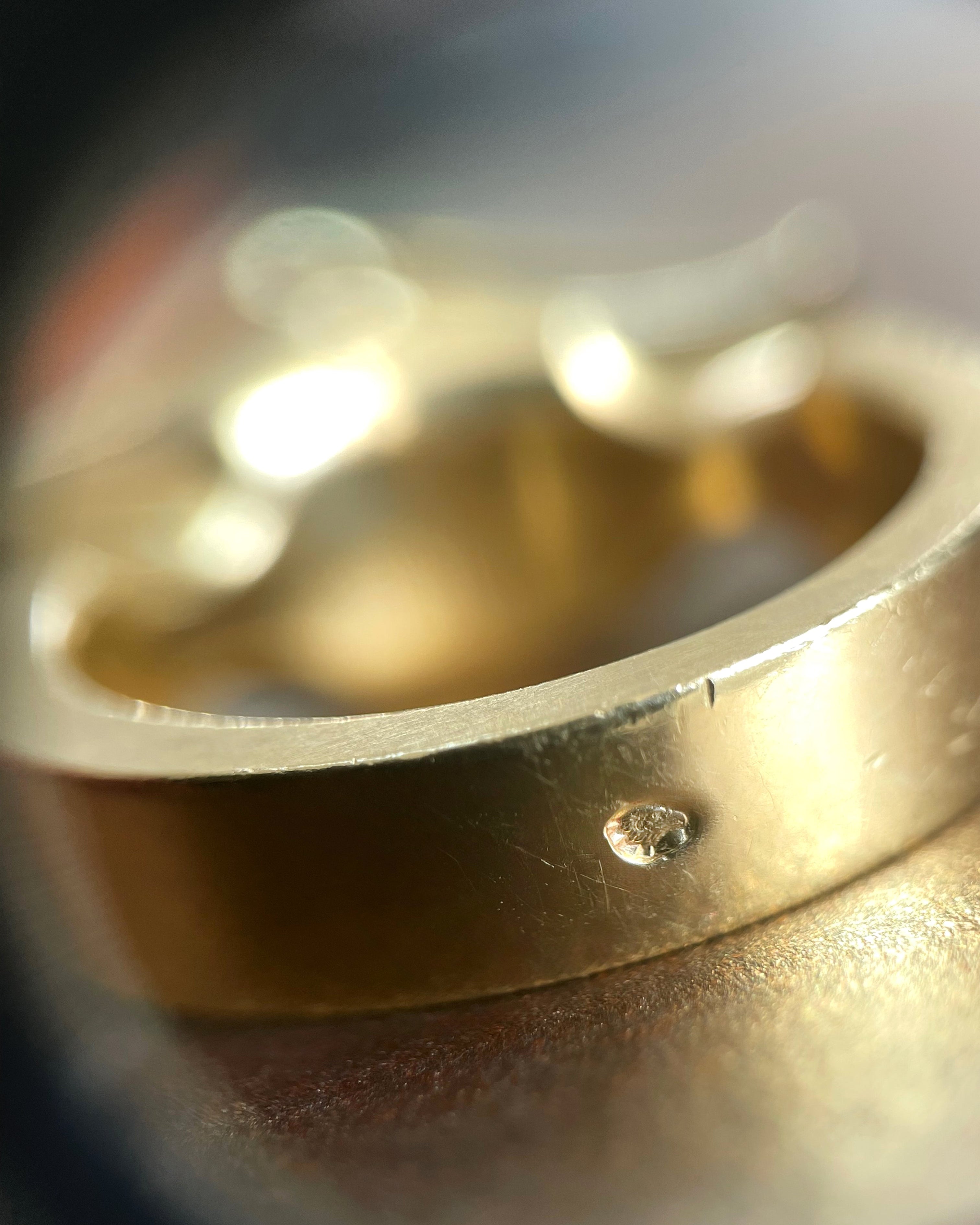 Close-up of French eagle's head 18kt gold hallmark inside modernist Tahitian black pearl iris ring – Auric Vintage