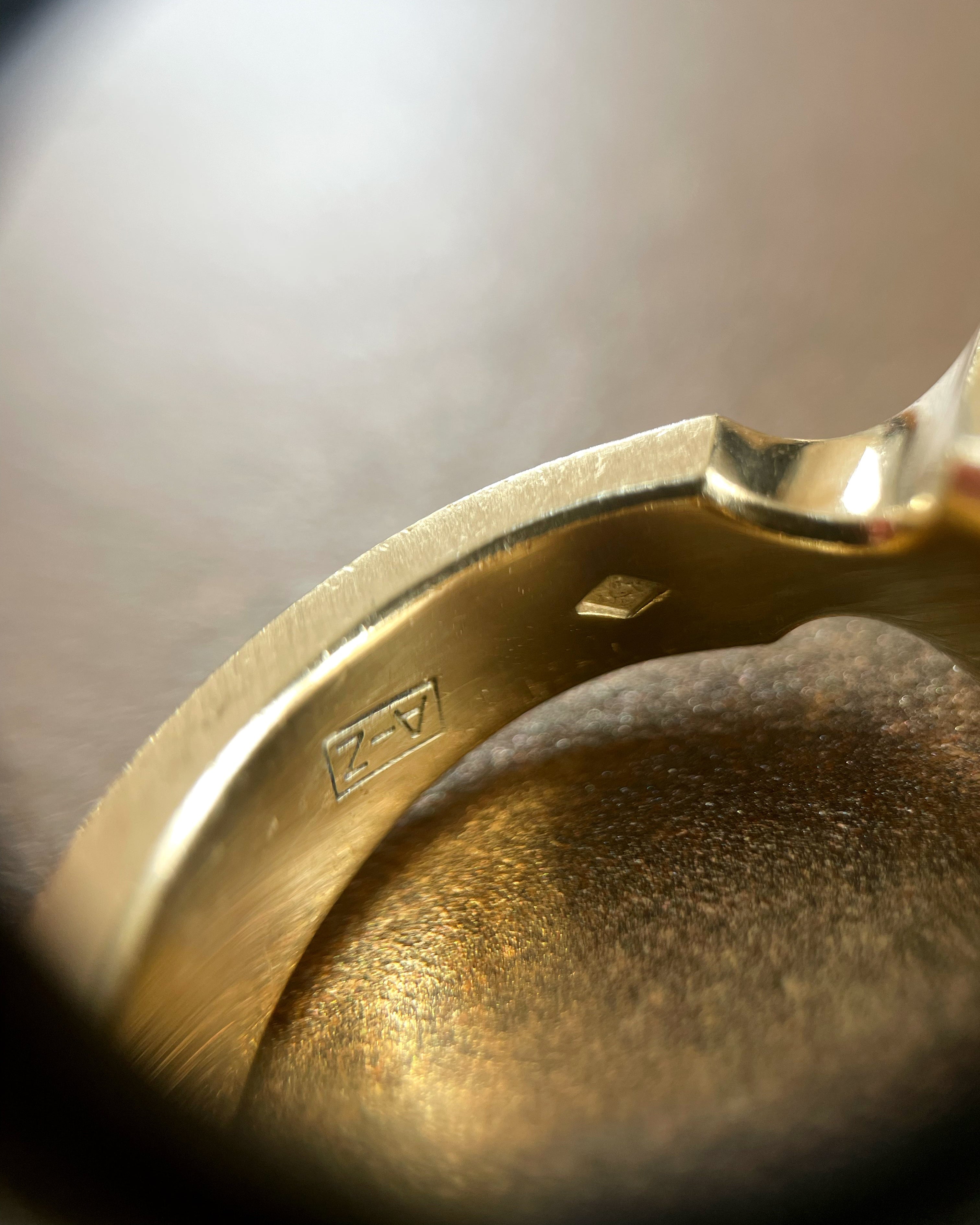 Close-up of maker's mark inside modernist French Tahitian black pearl iris ring in 18kt yellow gold – Auric Vintage