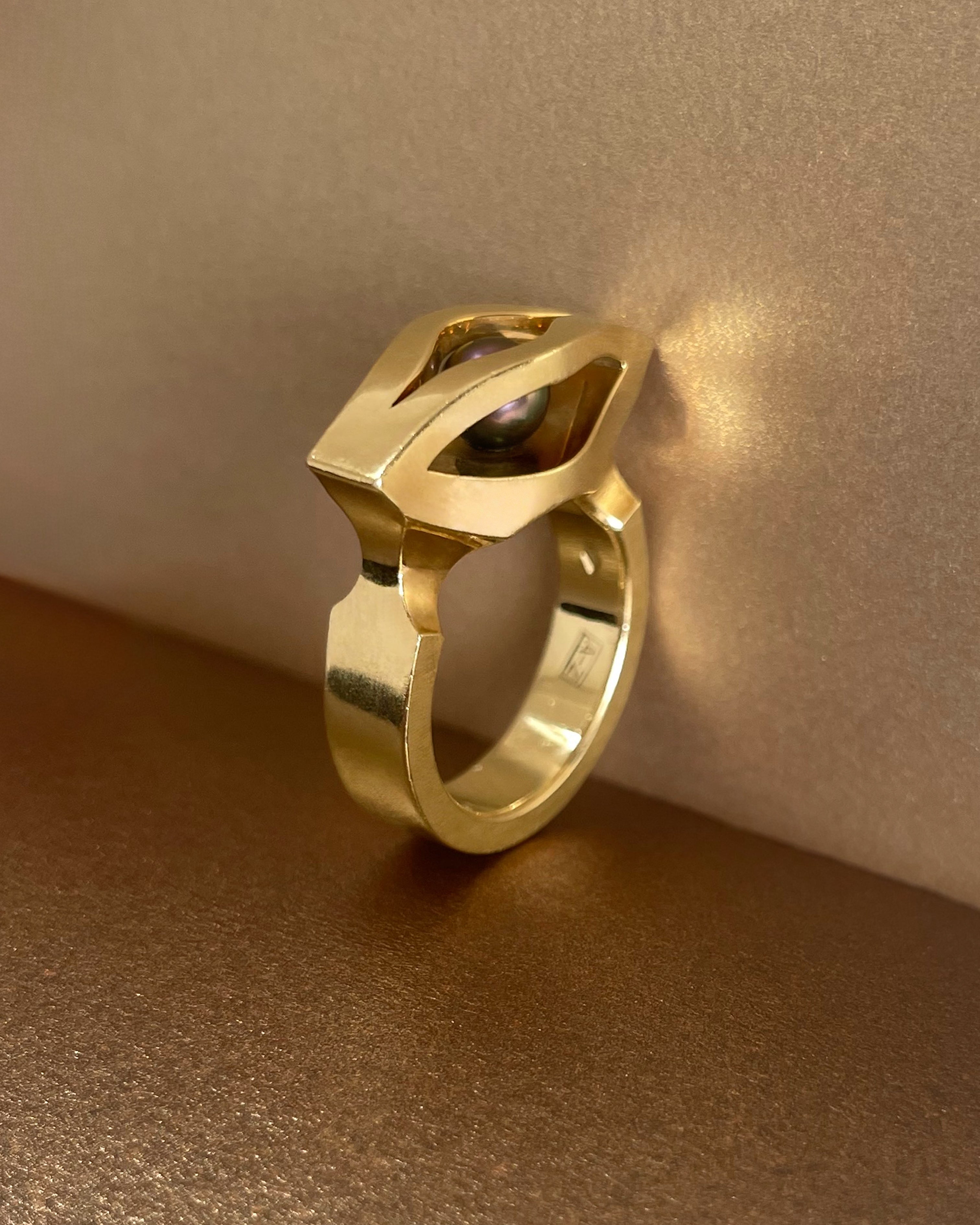 Side view of modernist French Tahitian black pearl iris ring in 18kt yellow gold showing sculptural openwork profile – Auric Vintage