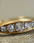 Magnified view of five antique diamonds set closely together in a boat-shaped Victorian navette ring, with approximately 0.50ct total diamond weight.