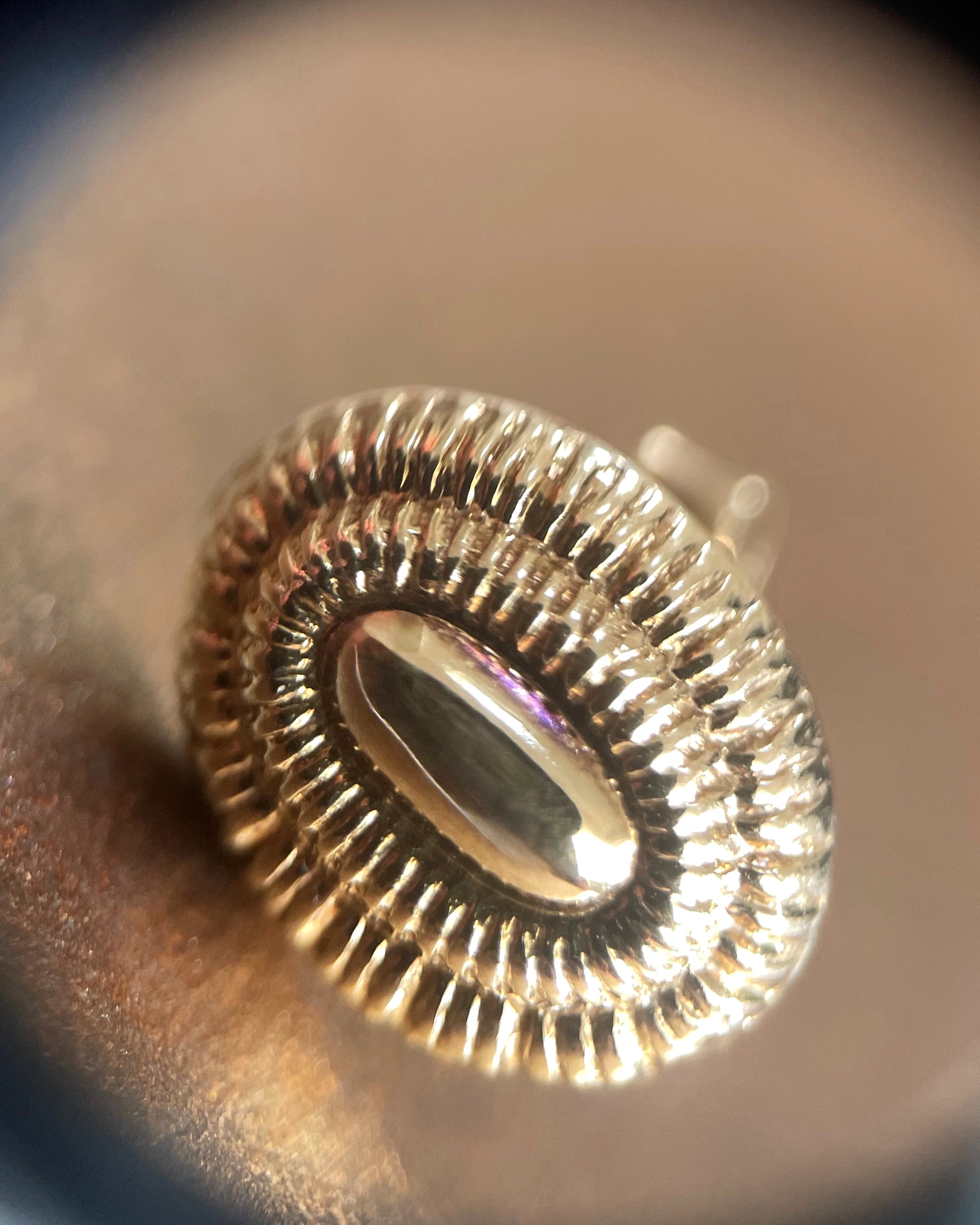 Close-up of ribbed terraced detailing on Seventies 9kt yellow gold stud earrings – Auric Vintage