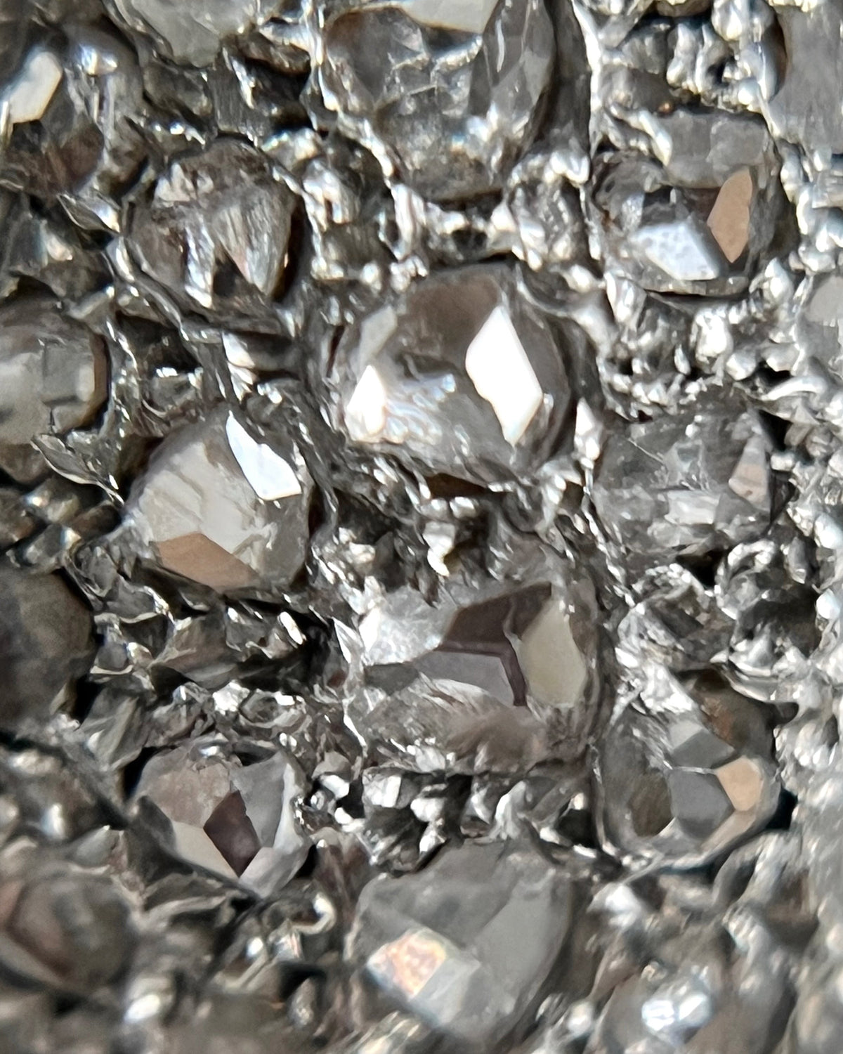 Magnified close-up of the rose cut diamonds set within silver grain settings on a 1940s vintage tank ring.