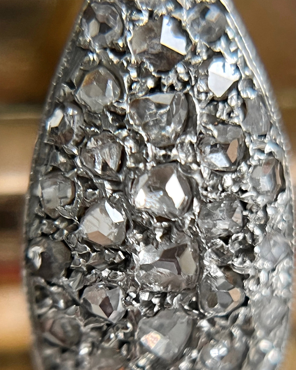 Detailed close-up of the silver grain settings surrounding the rose cut diamonds on a 1940s vintage tank ring.
