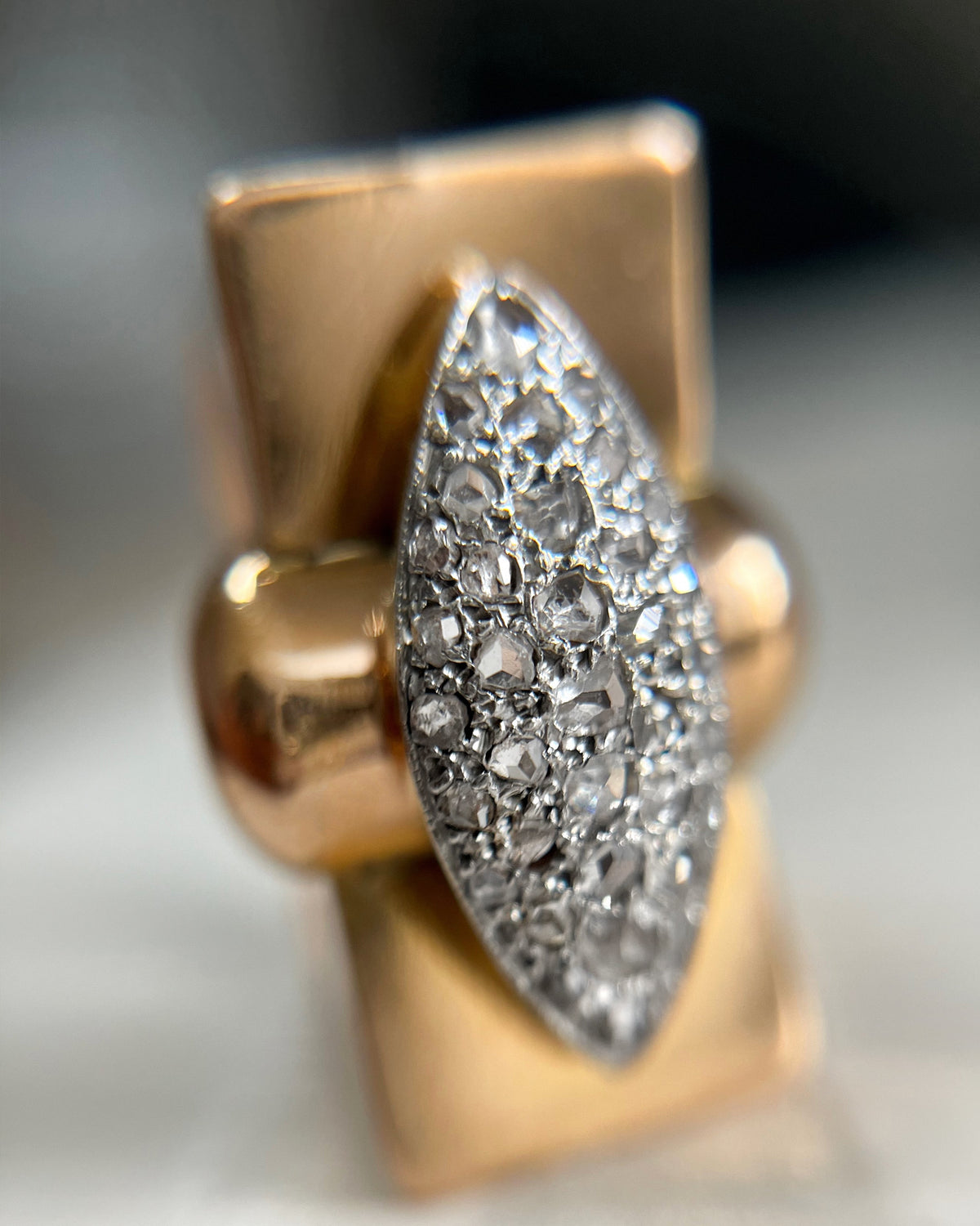 Front view of a 1940s vintage tank ring featuring a horizontal marquise-shaped cluster of rose cut diamonds in silver settings.