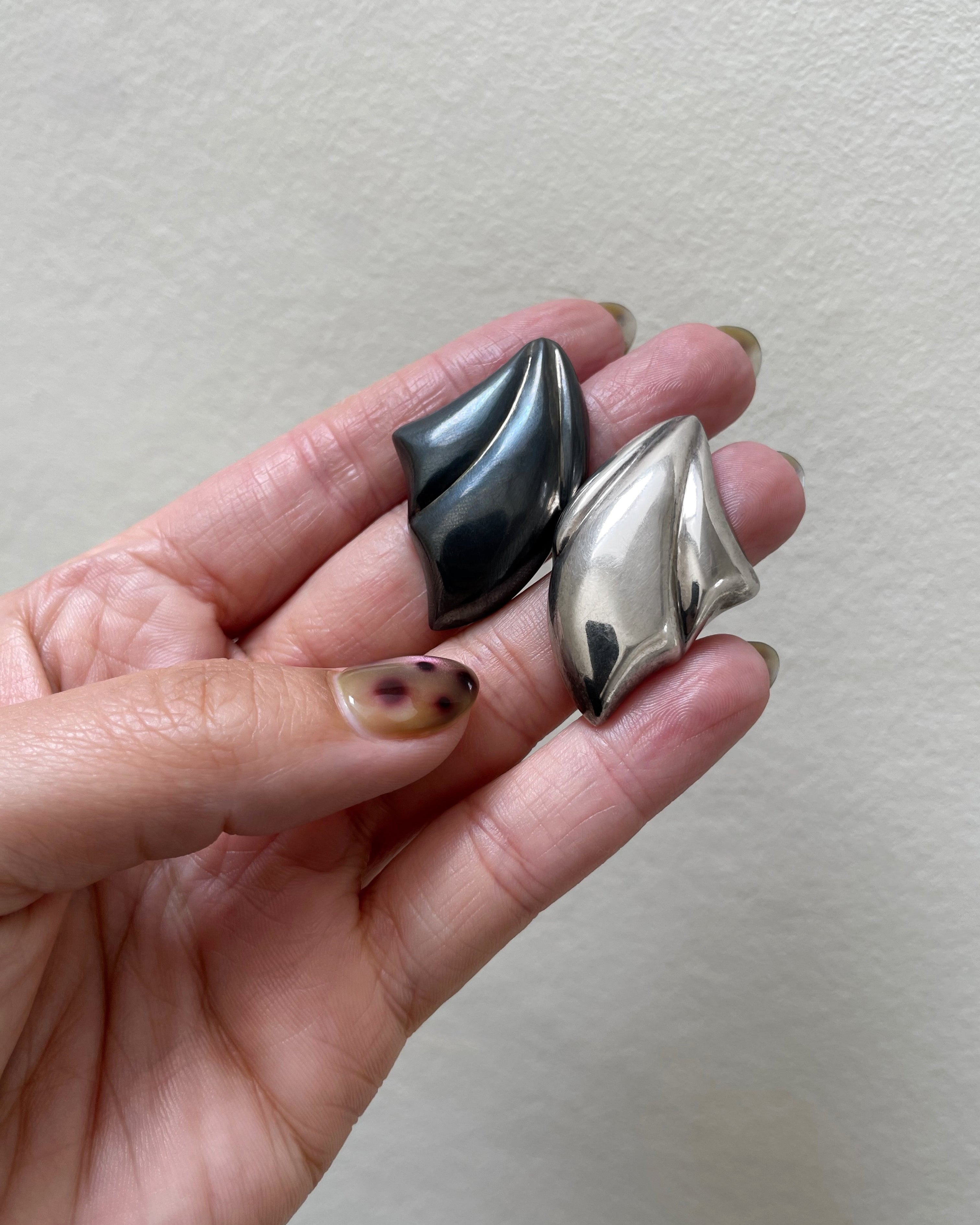 1980s sterling silver sculptural earrings held in hand showing scale and design – Auric Vintage