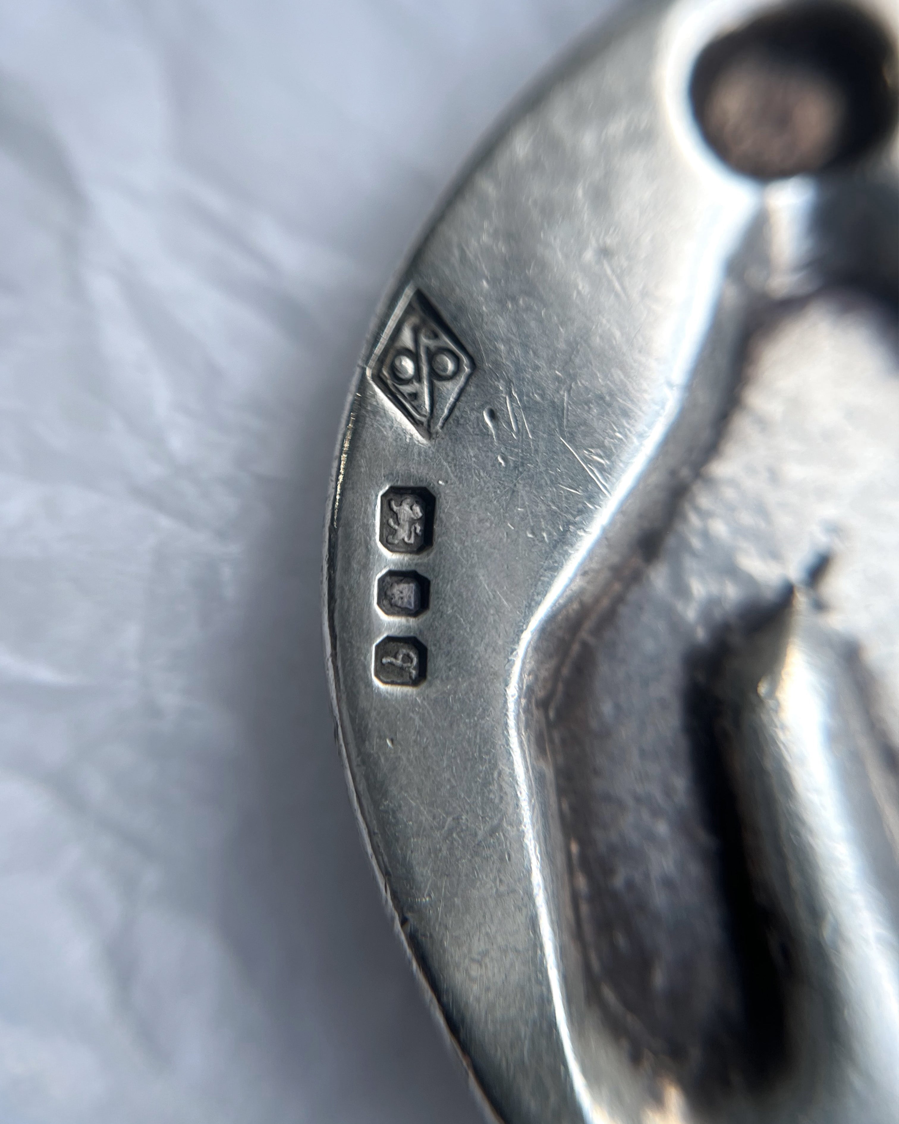 Close-up of 1970s sterling silver St. Christopher medallion showing London hallmark and maker’s mark – Auric Vintage