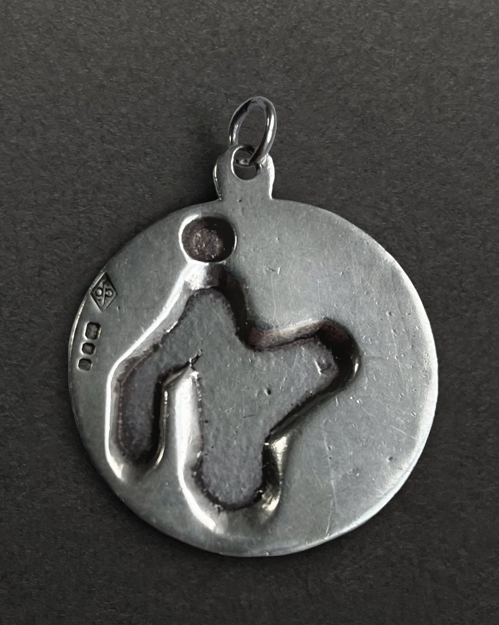 Reverse of 1970s sterling silver St. Christopher medallion showing smooth finish – Auric Vintage