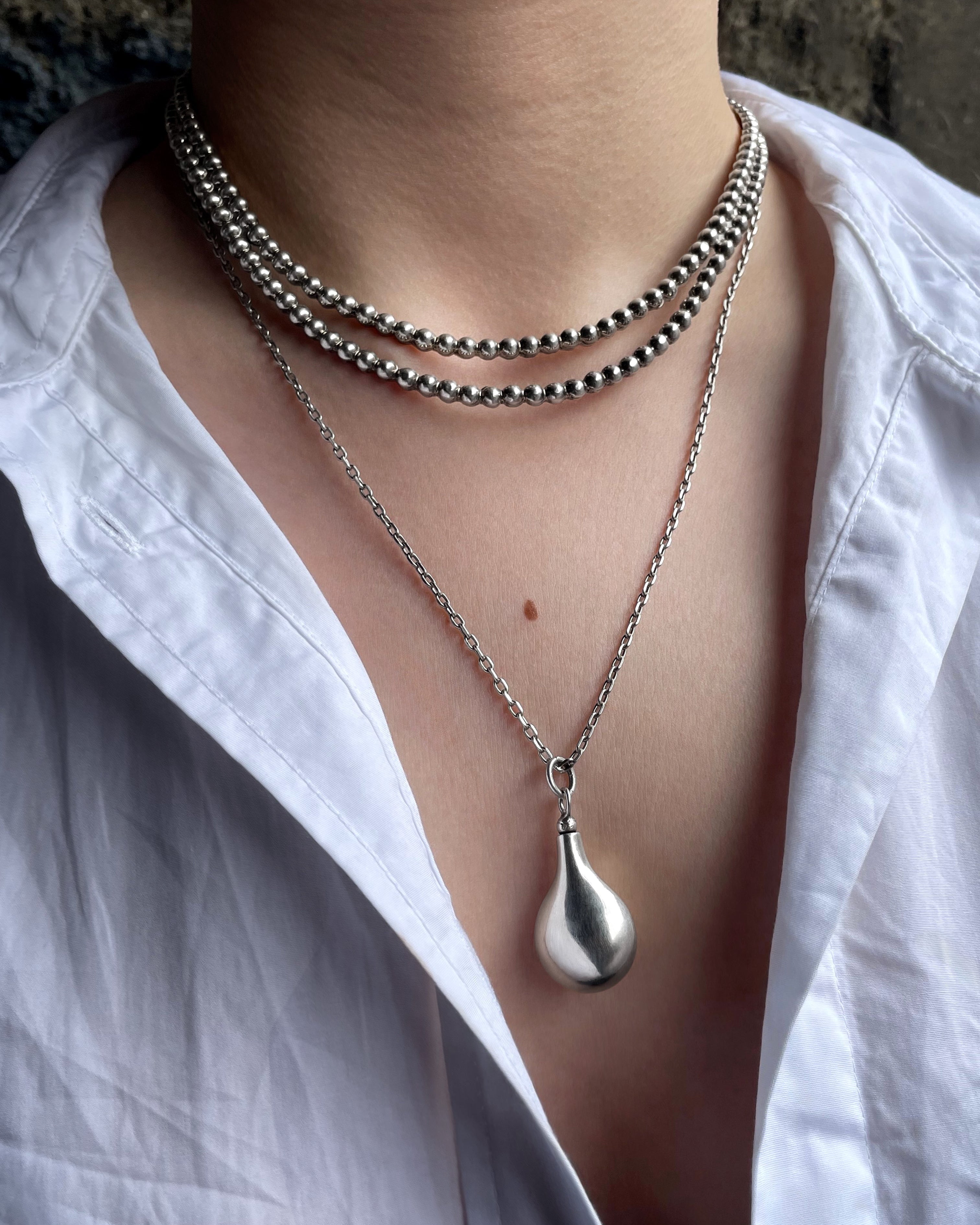 Y2K bubble torque collar in Sterling silver layered with a silver chain and vessel pendant – Auric Vintage
