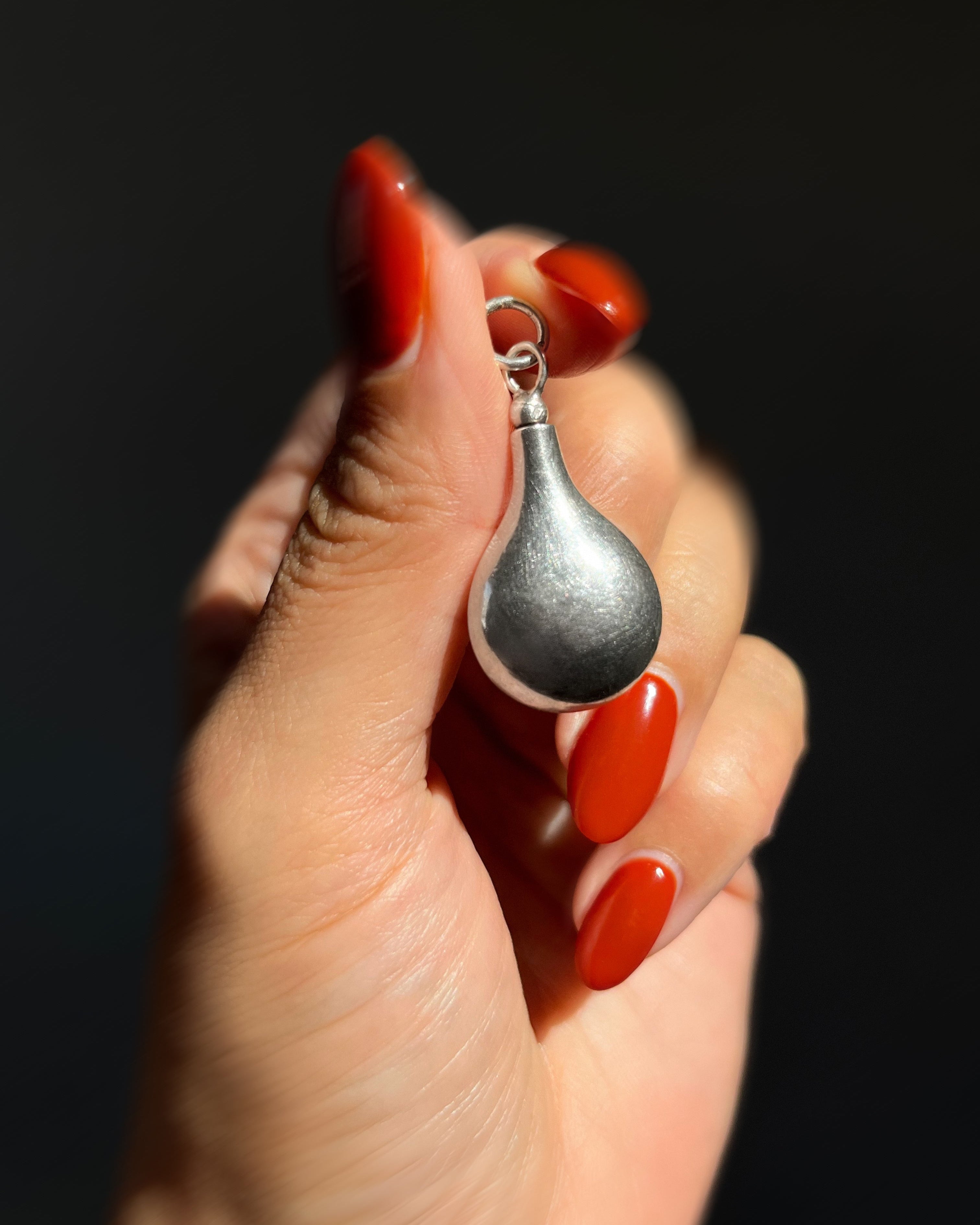 1980s Sterling silver vessel pendant held in hand for scale – Auric Vintage