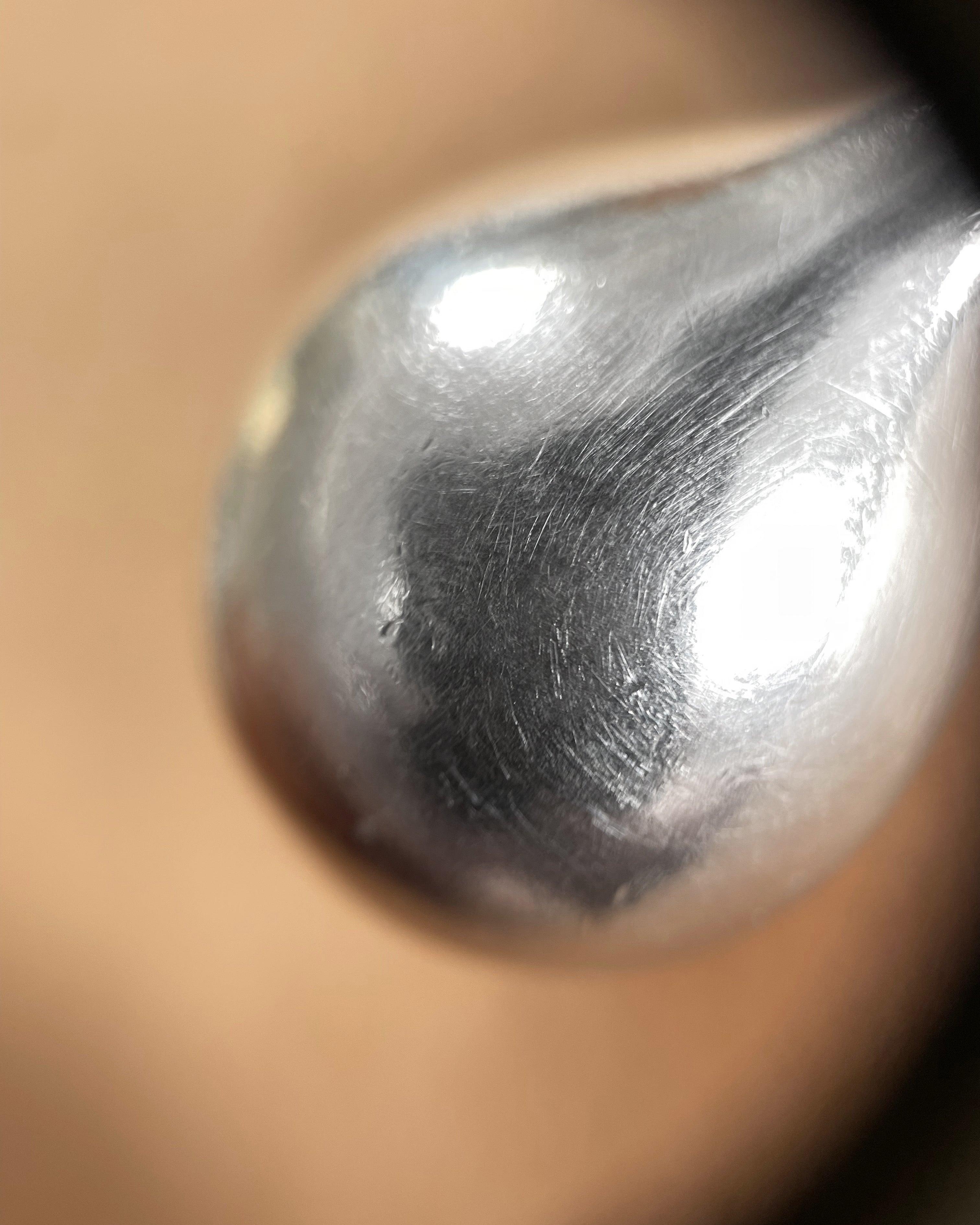Close-up of polished sculptural surface on 1980s Sterling silver vessel pendant – Auric Vintage