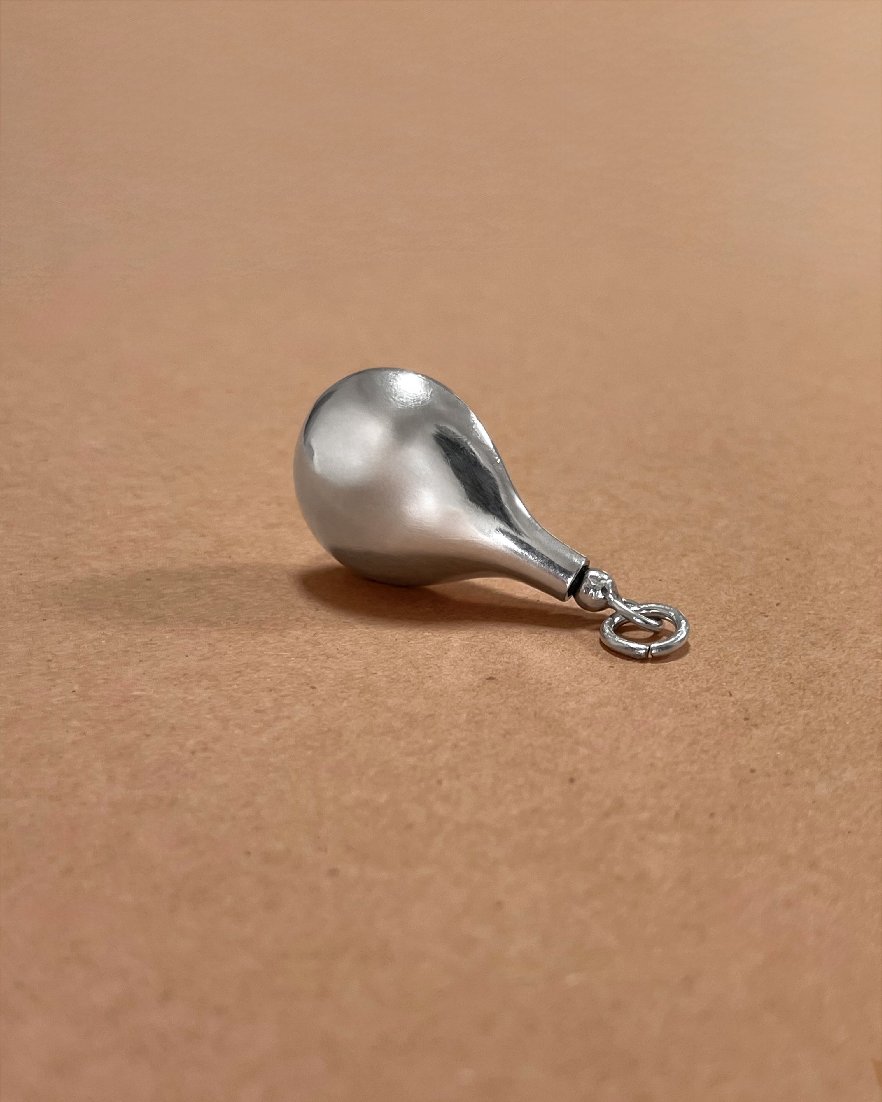 Side view of 1980s Sterling silver vessel pendant showing sculptural teardrop profile – Auric Vintage
