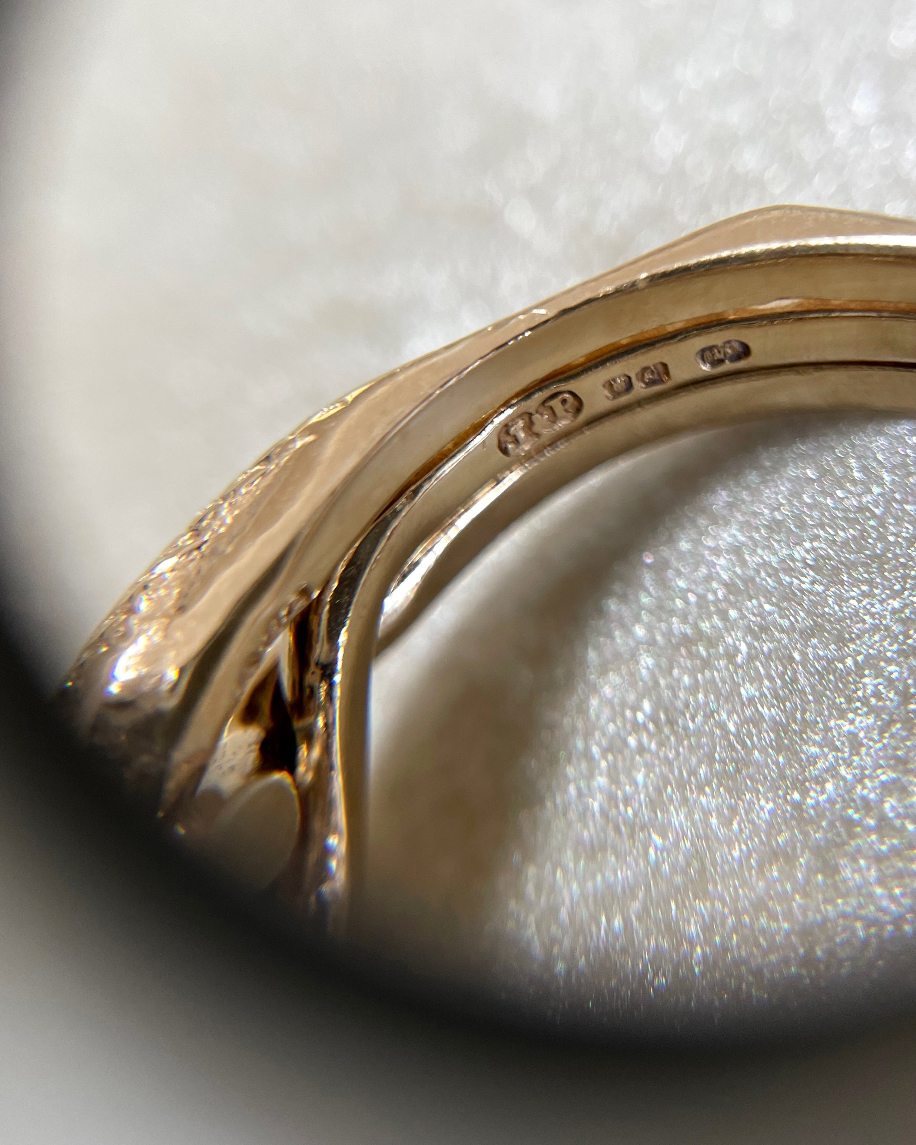 Close-up of London 1990 hallmarks inside vintage British 9kt yellow gold puzzle ring – Auric Vintage