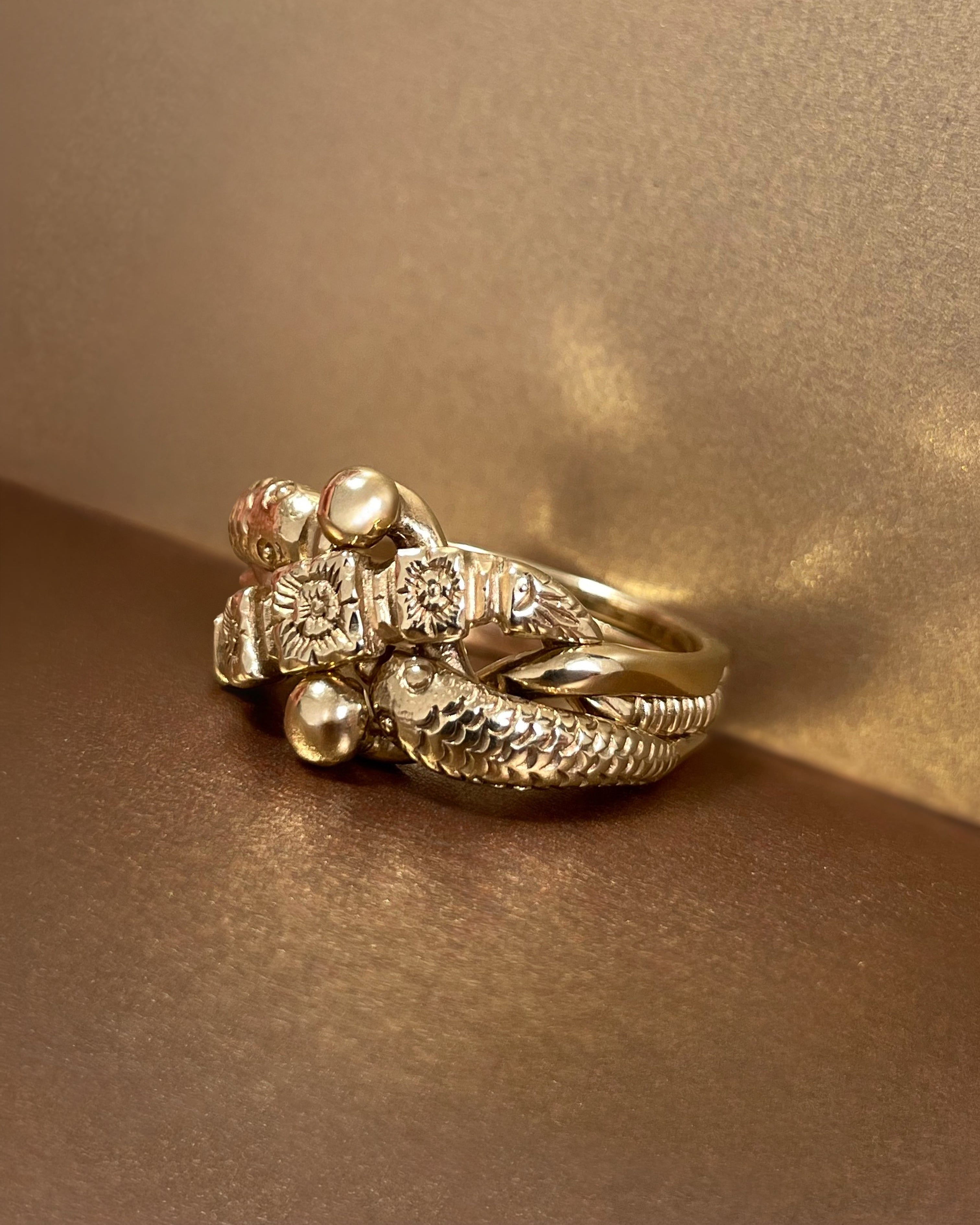 Profile view of vintage British flower and serpent puzzle ring in 9kt yellow gold – Auric Vintage