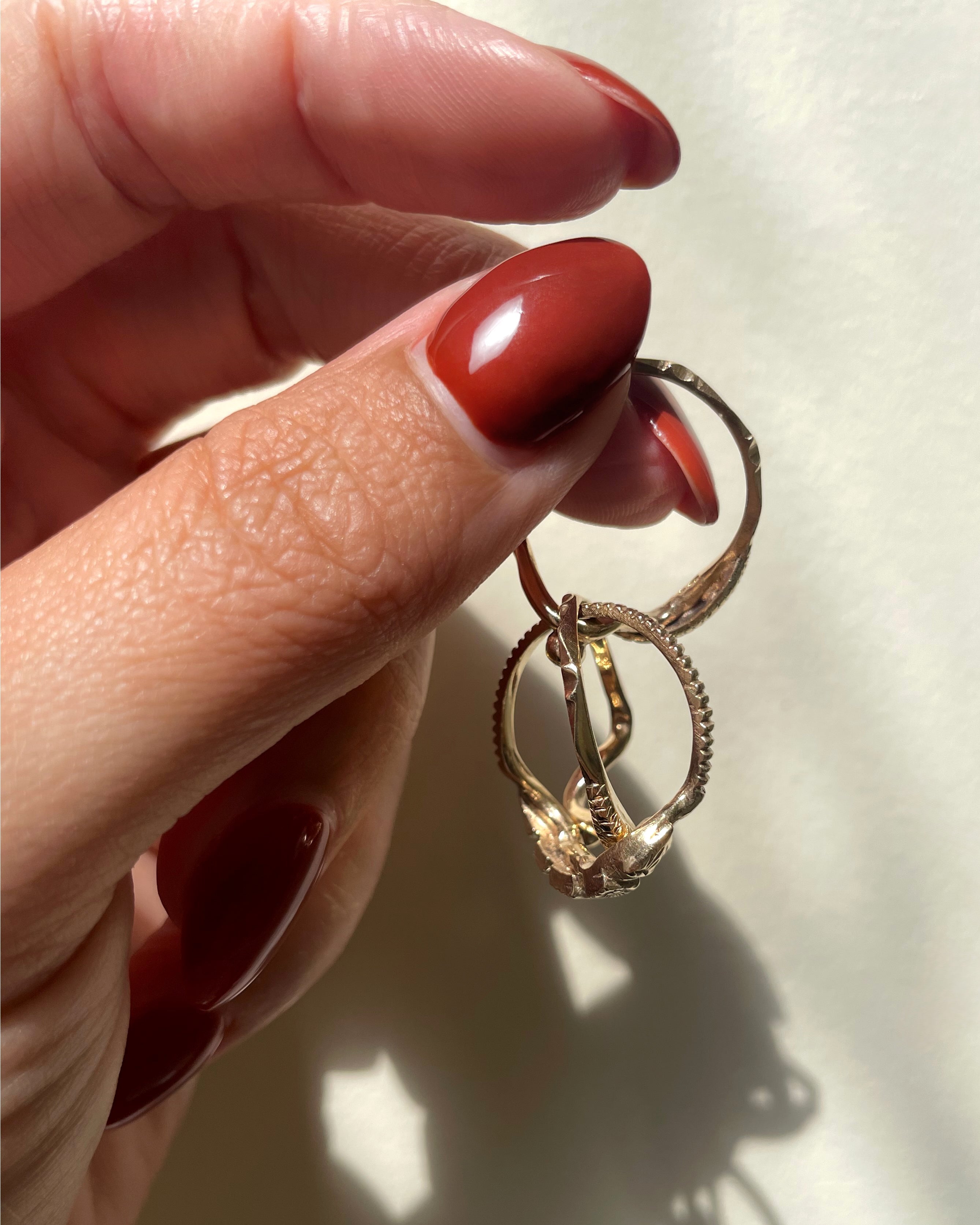 Vintage British flower and serpent puzzle ring in 9kt yellow gold separated to show interlocking construction, held in hand – Auric Vintage”