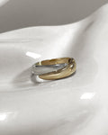 Vintage 9kt two-tone gold ring, hallmarked Sheffield 1994, featuring interwoven white and yellow gold with a deep incised central rib.