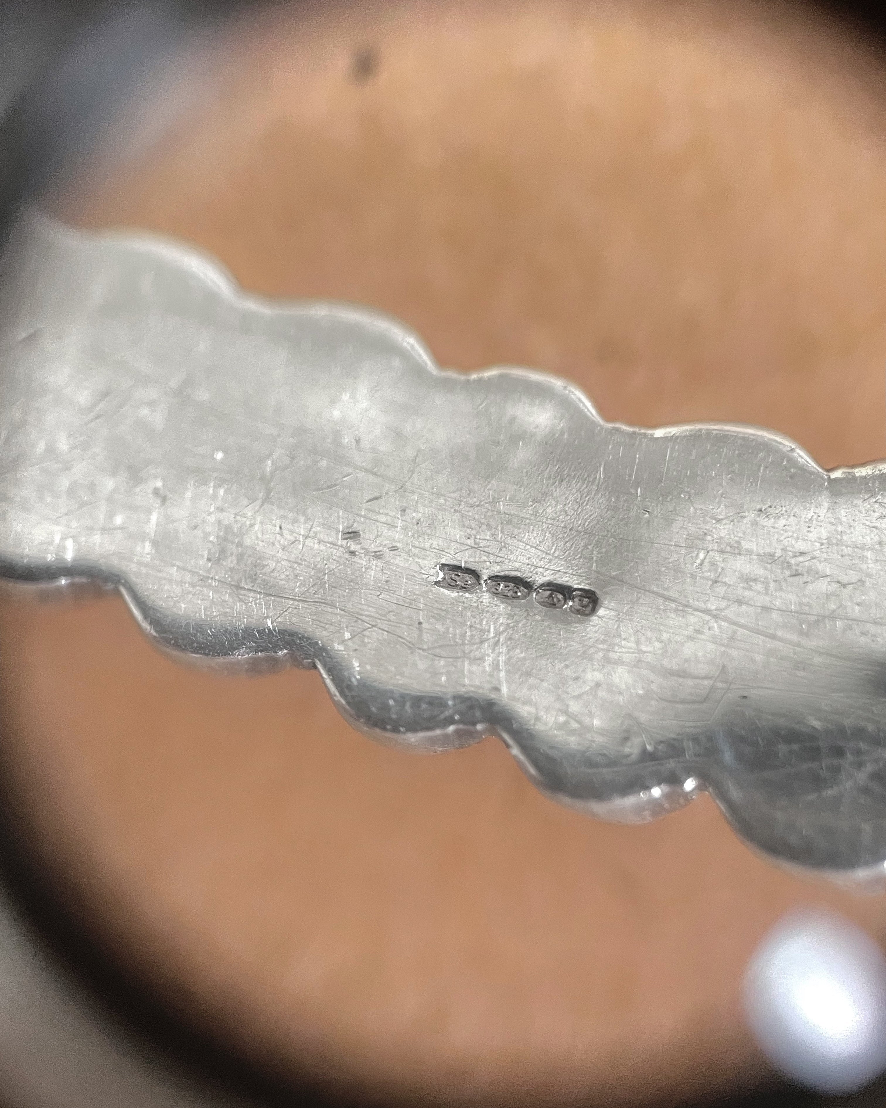 Close-up of Birmingham 1998 hallmarks on Y2K Sterling silver bubble torque collar – Auric Vintage