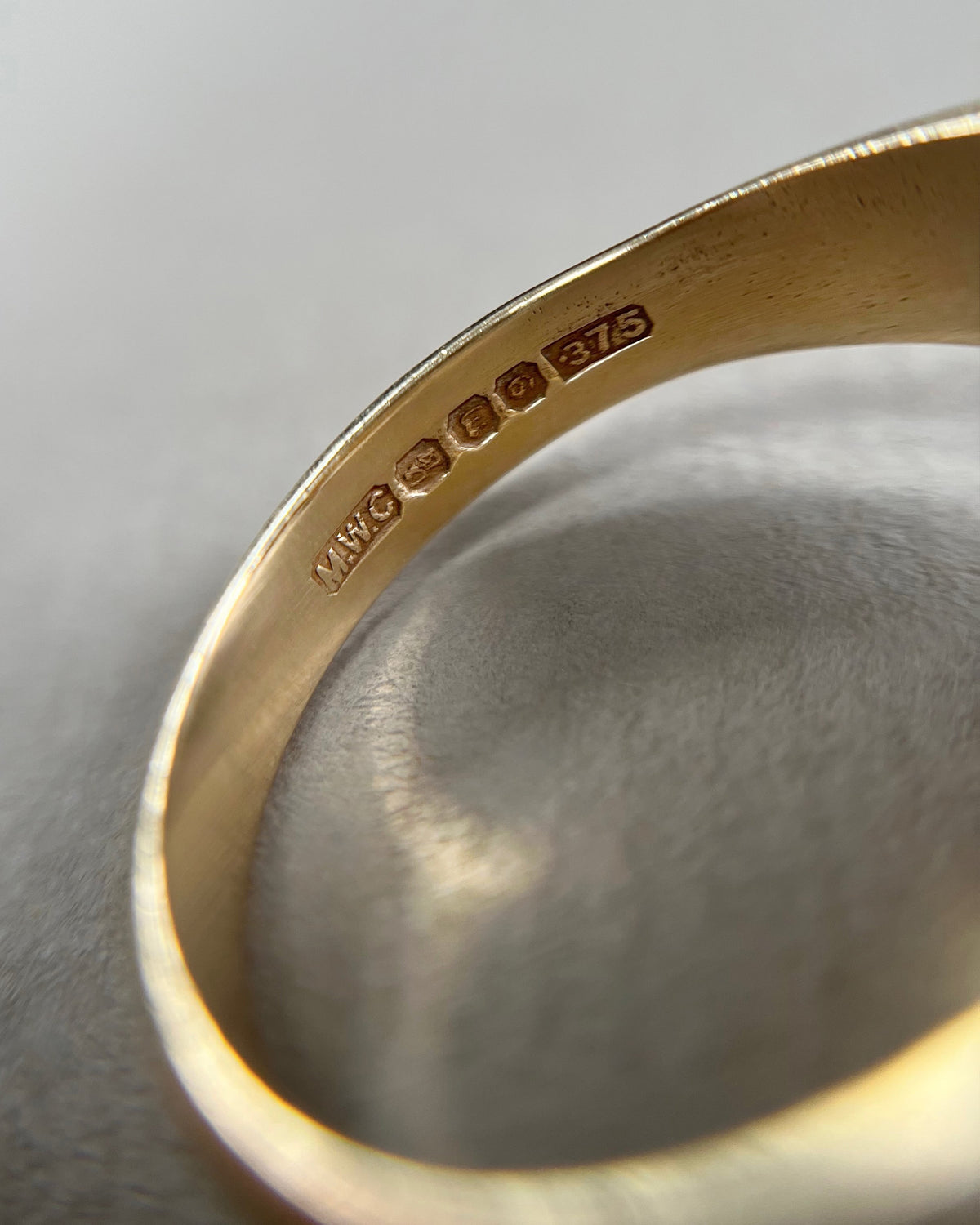 Magnified close-up of the Hibernia Dublin Assay Office hallmark, 9kt gold mark and 1978 date letter inside a vintage Irish shamrock ring.