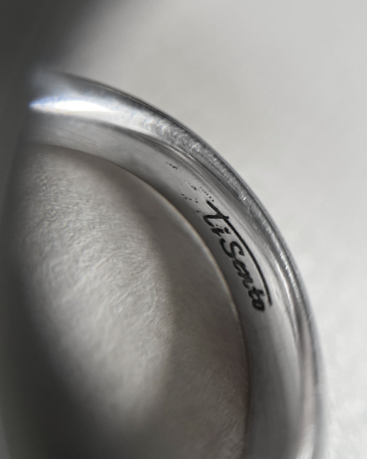 Magnified close-up of the Ti Sento signature on a Sterling silver bauble stacking ring.