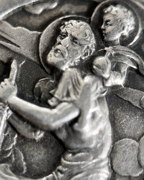 Magnified detail of 1960s French 800 silver St Christopher pendant showing St Christopher, Christ Child, turbulent waters and clouded sky