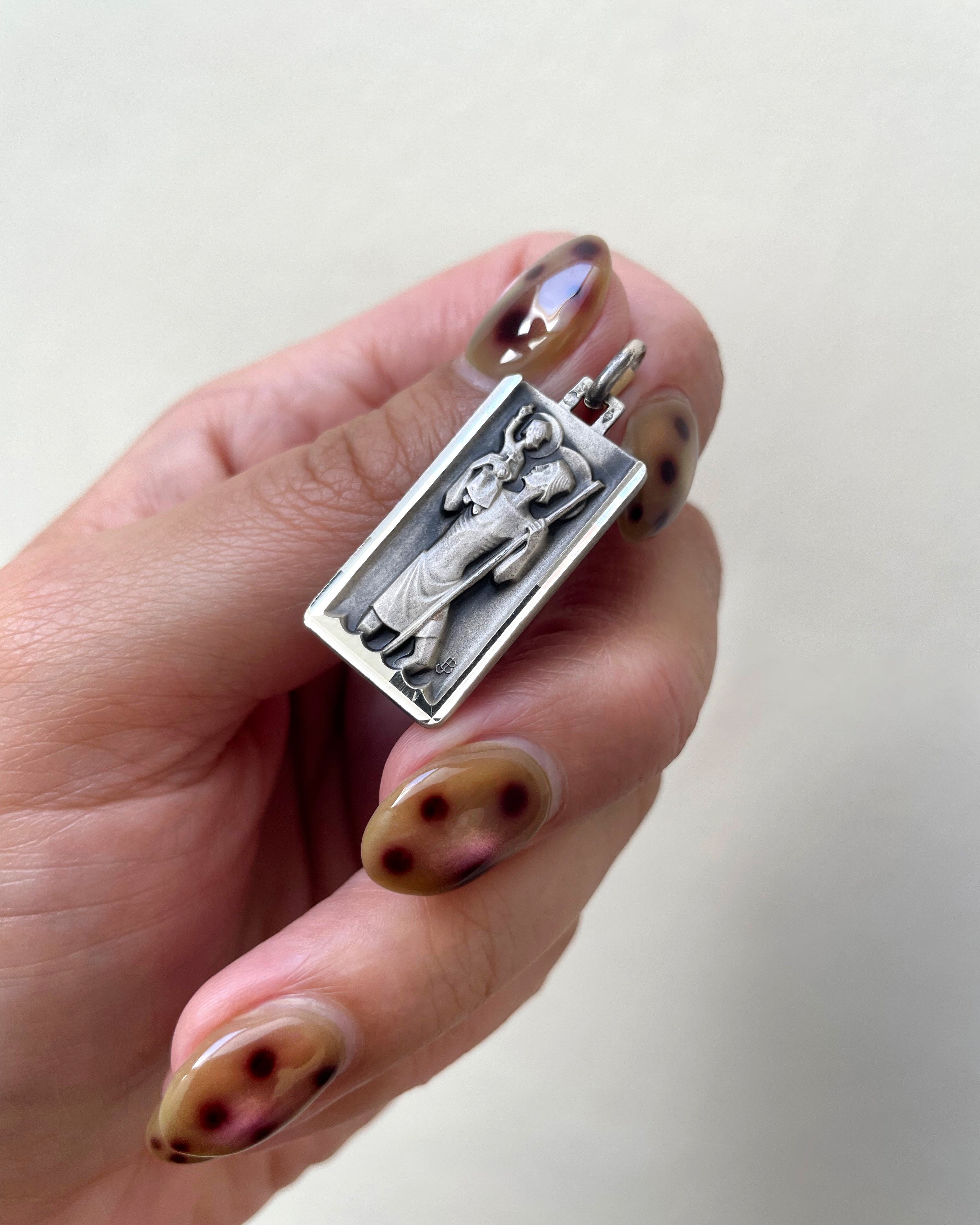 Mid century French St. Christopher pendant in 800 silver held in hand showing scale and detail – Auric Vintage