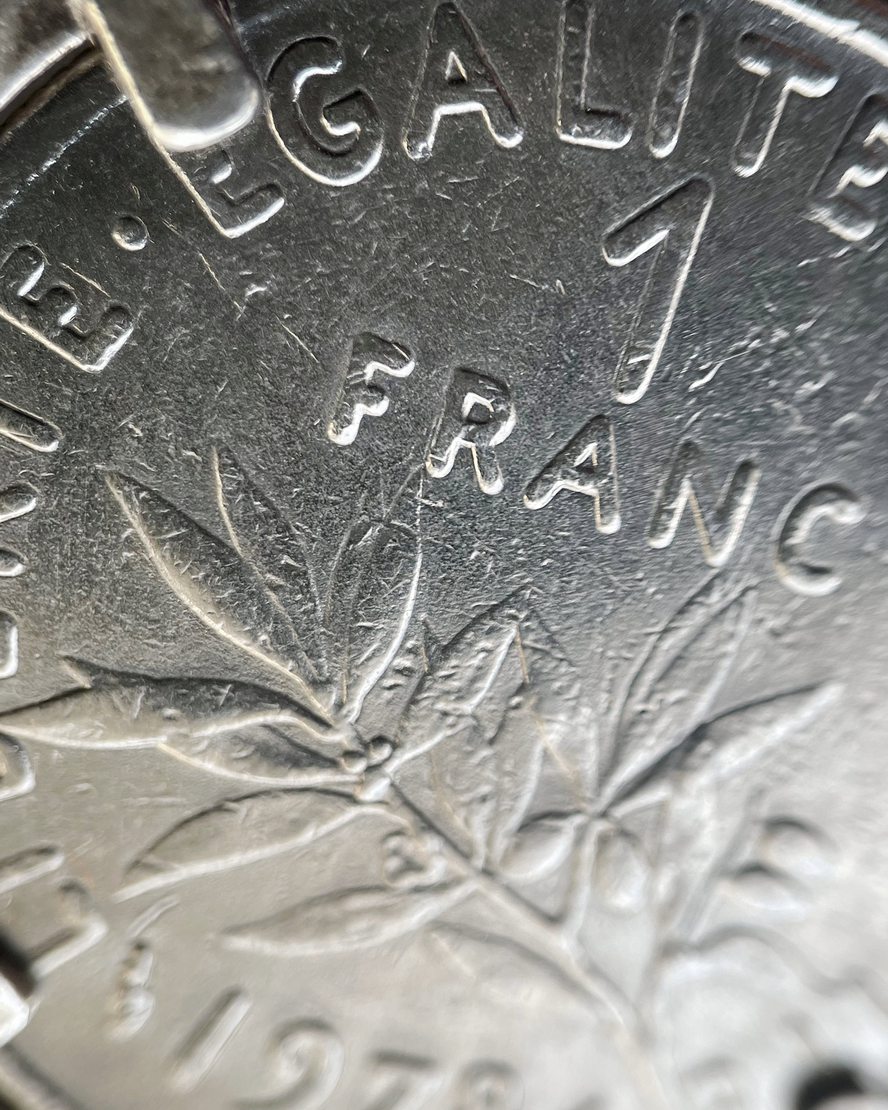 Close-up of Arthus Bertrand sterling silver 1 Franc coin sautoir showing Franc side of French coin – Auric Vintage