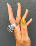 Vintage Sterling silver sculptural dress ring with seven graduating open ridges forming a bold terraced design, shown from the side on a hand.