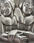 Close-up of 1940s French sterling silver Gemini pendant depicting two angular entwined figures in a sculptural Art Deco style