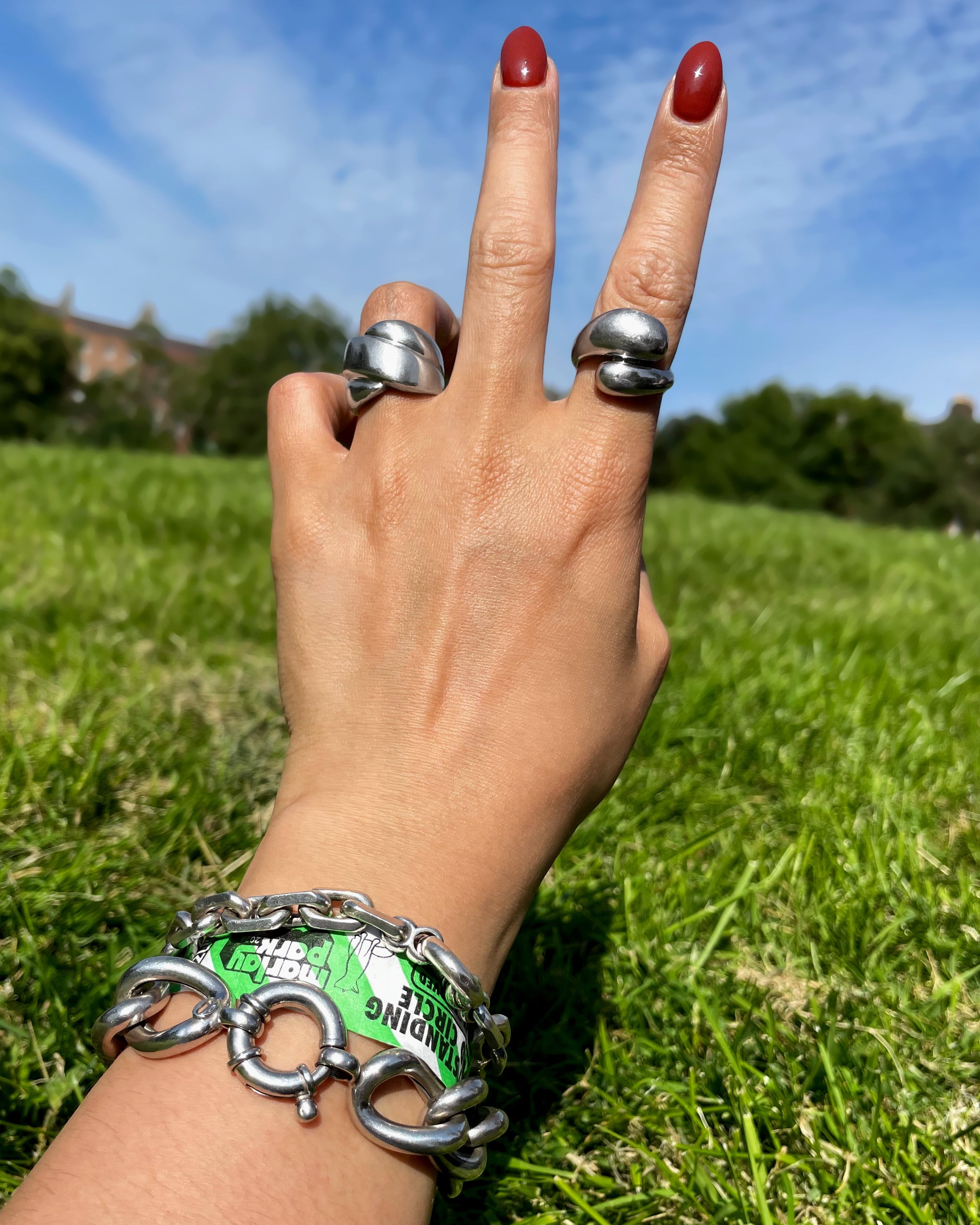Y2K bypass ring in sterling silver worn on hand with crossover ring and two silver bracelets – Auric Vintage