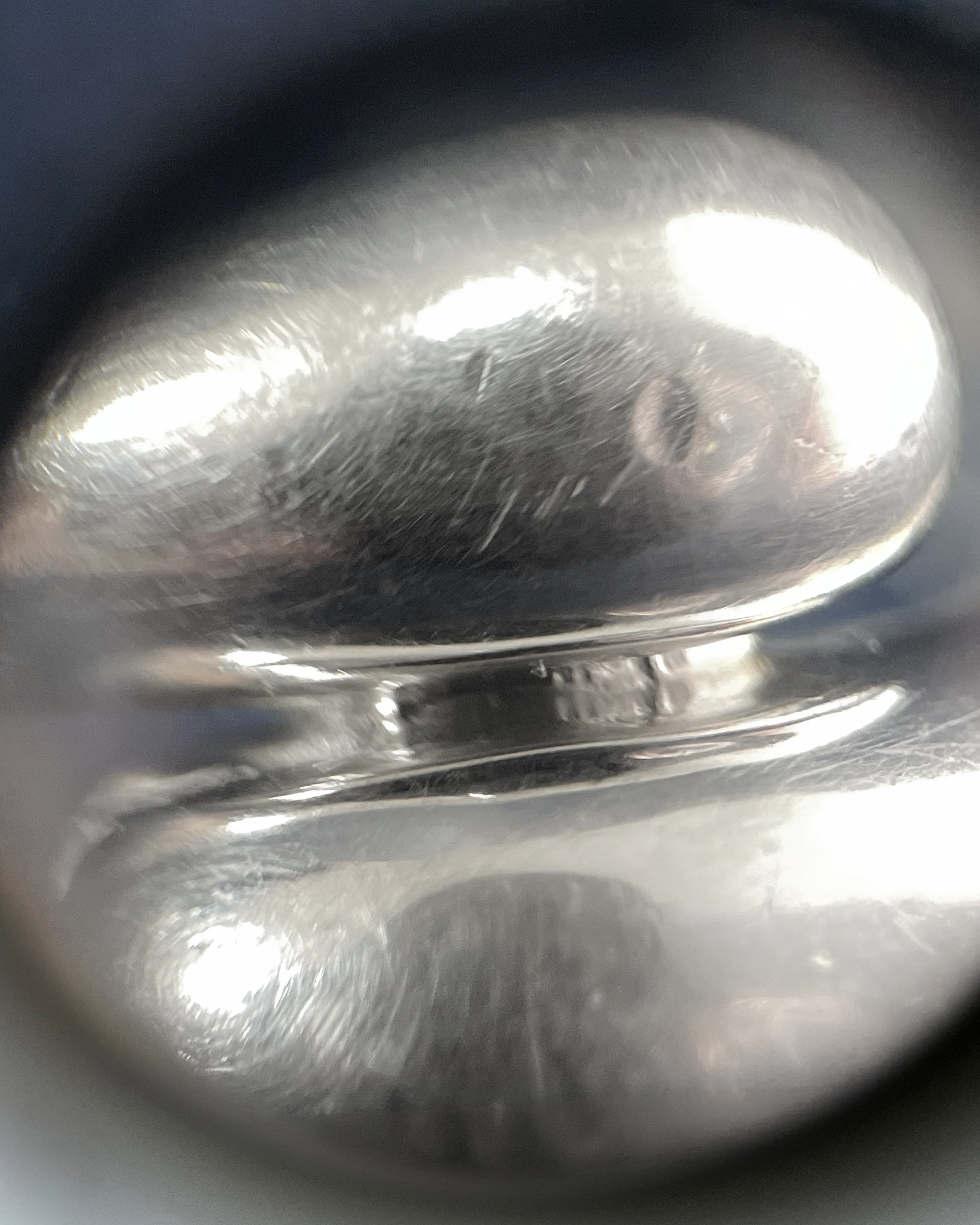Close-up of Y2K bypass ring in sterling silver showing polished three-dimensional bypass curves – Auric Vintage”
