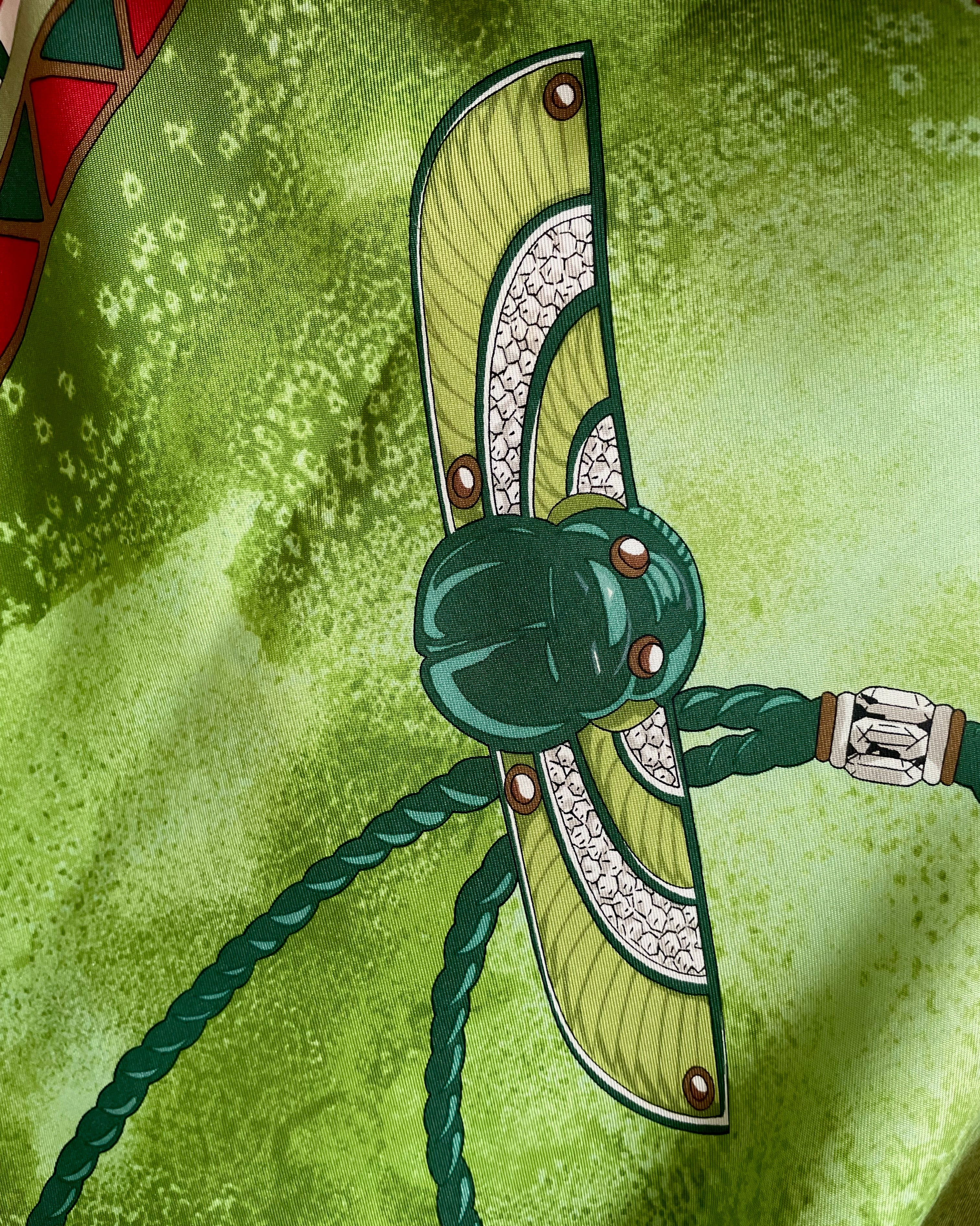 Close-up of Scarab Brooch motif on vintage light green Must de Cartier Le Scarabée silk scarf – Auric Vintage