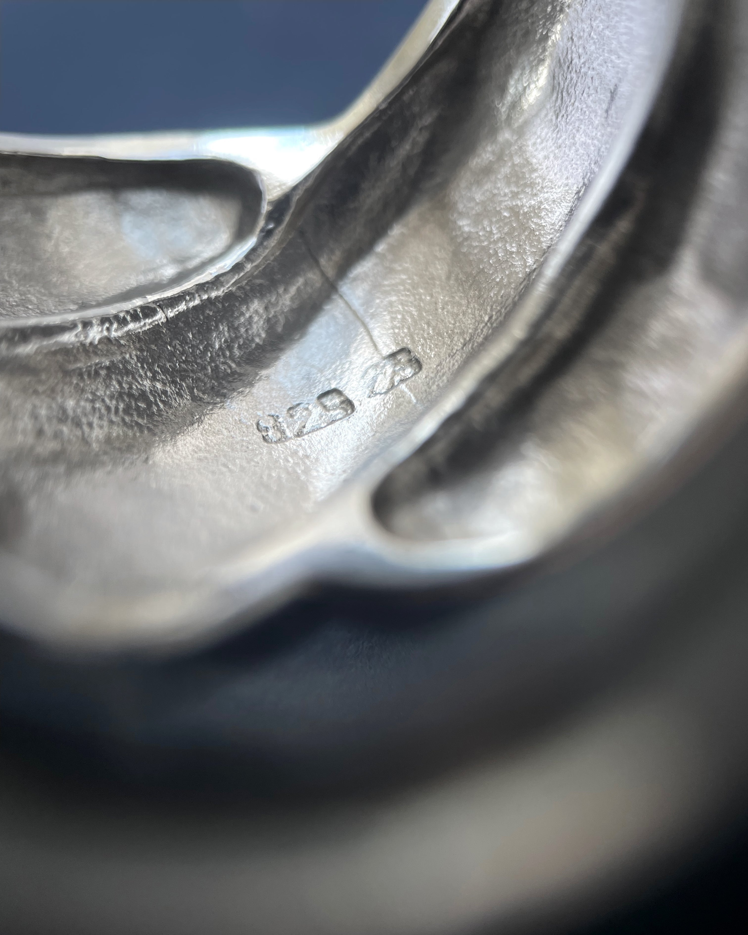 Close-up of 1970s French chunky crossover ring in sterling silver showing silver hallmark on reverse – Auric Vintage