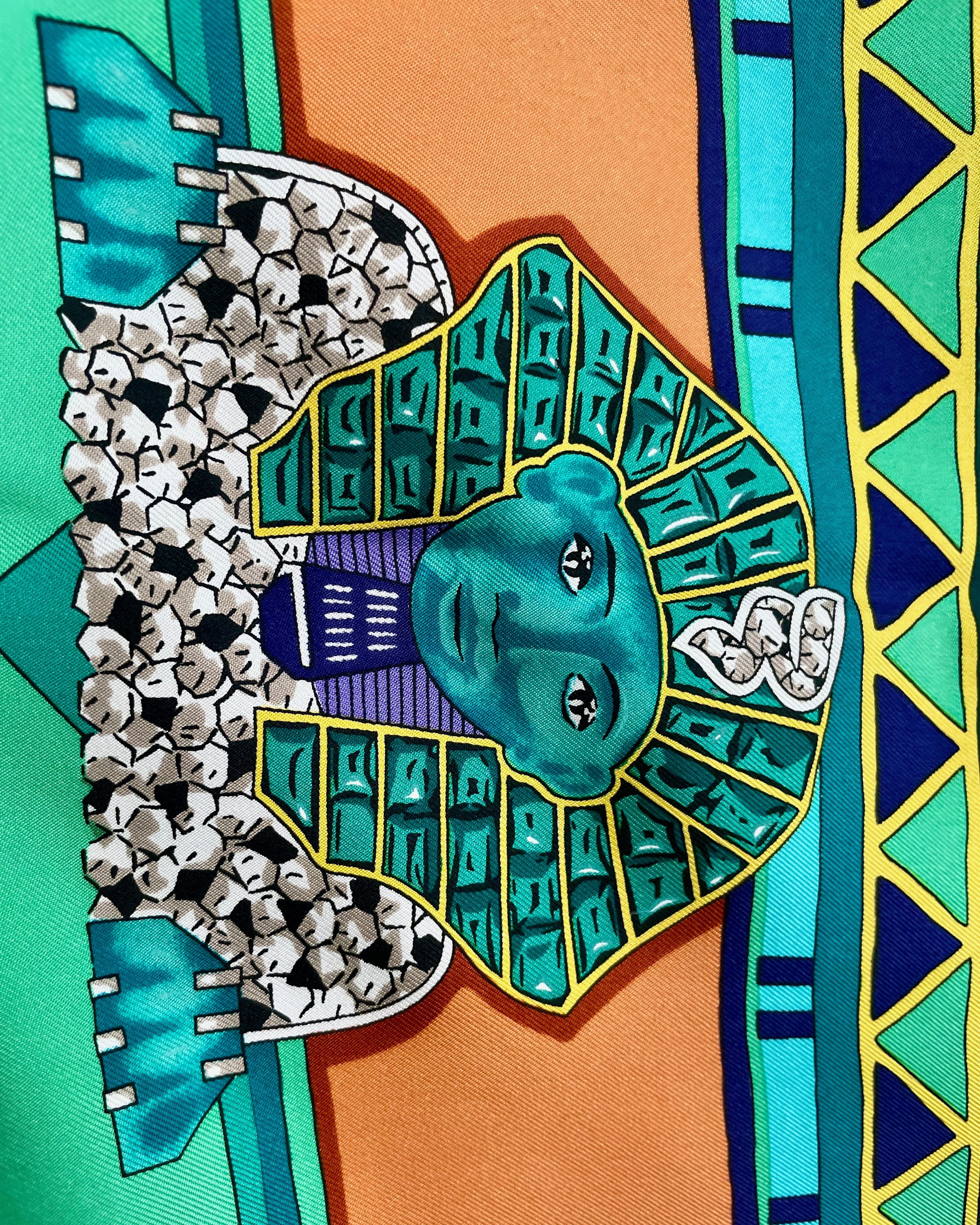 Close-up of Sphinx motif on vintage dark green Must de Cartier Le Scarabée silk scarf – Auric Vintage