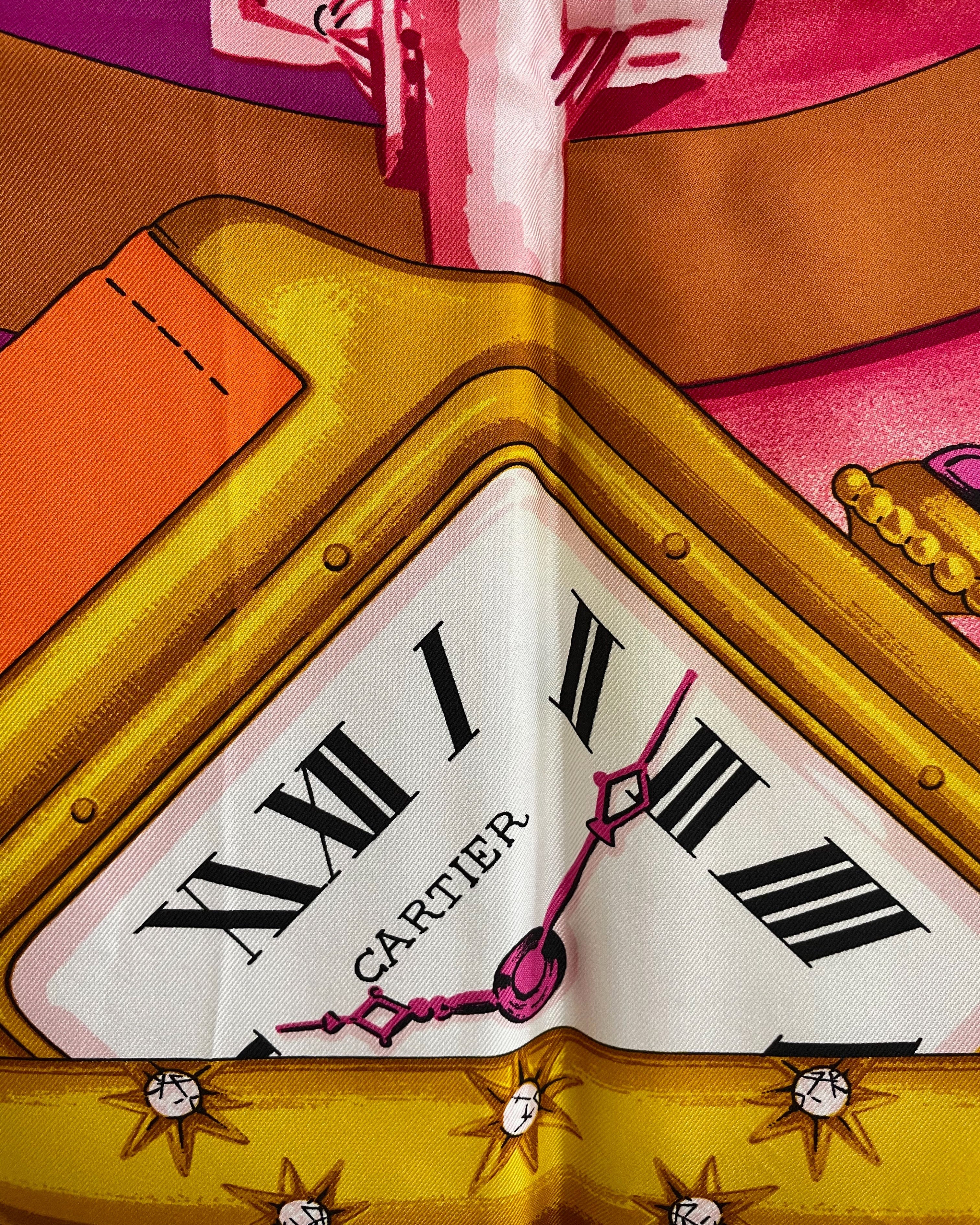 Close-up of vintage Must de Cartier silk scarf showing Santos de Cartier watch motif