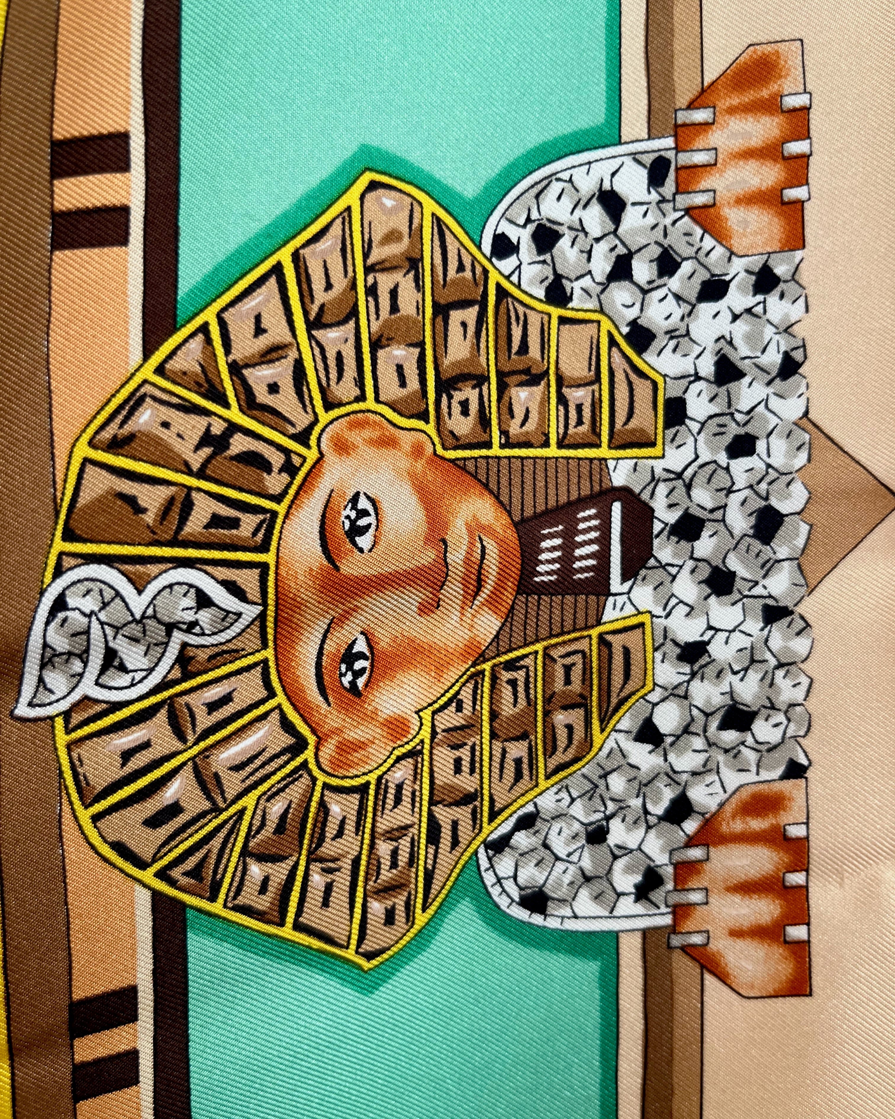 Close-up of Sphinx motif on vintage brown Must de Cartier Le Scarabée silk scarf – Auric Vintage