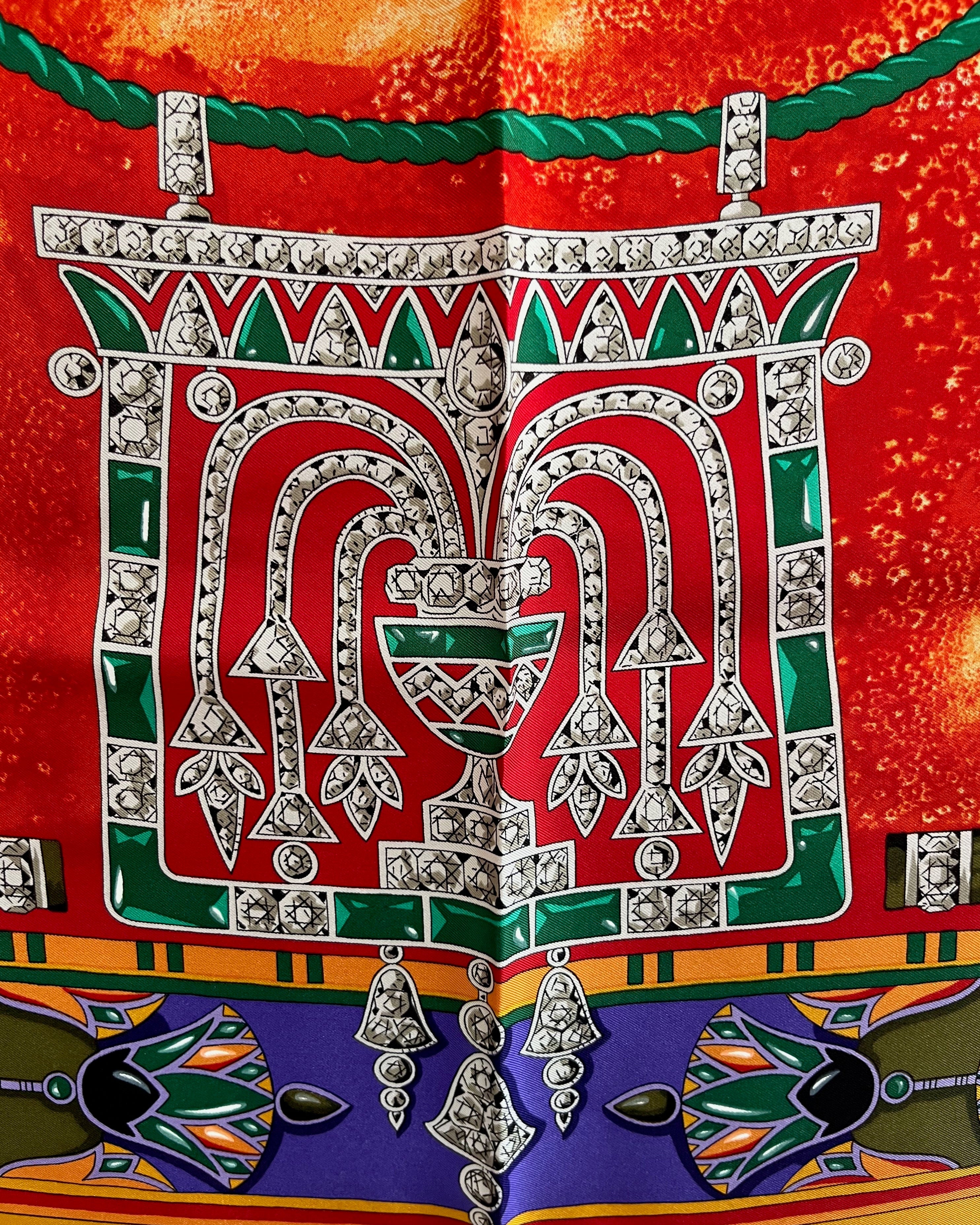 Close-up of Egyptian Pendant motif on vintage red Must de Cartier Le Scarabée silk scarf – Auric Vintage