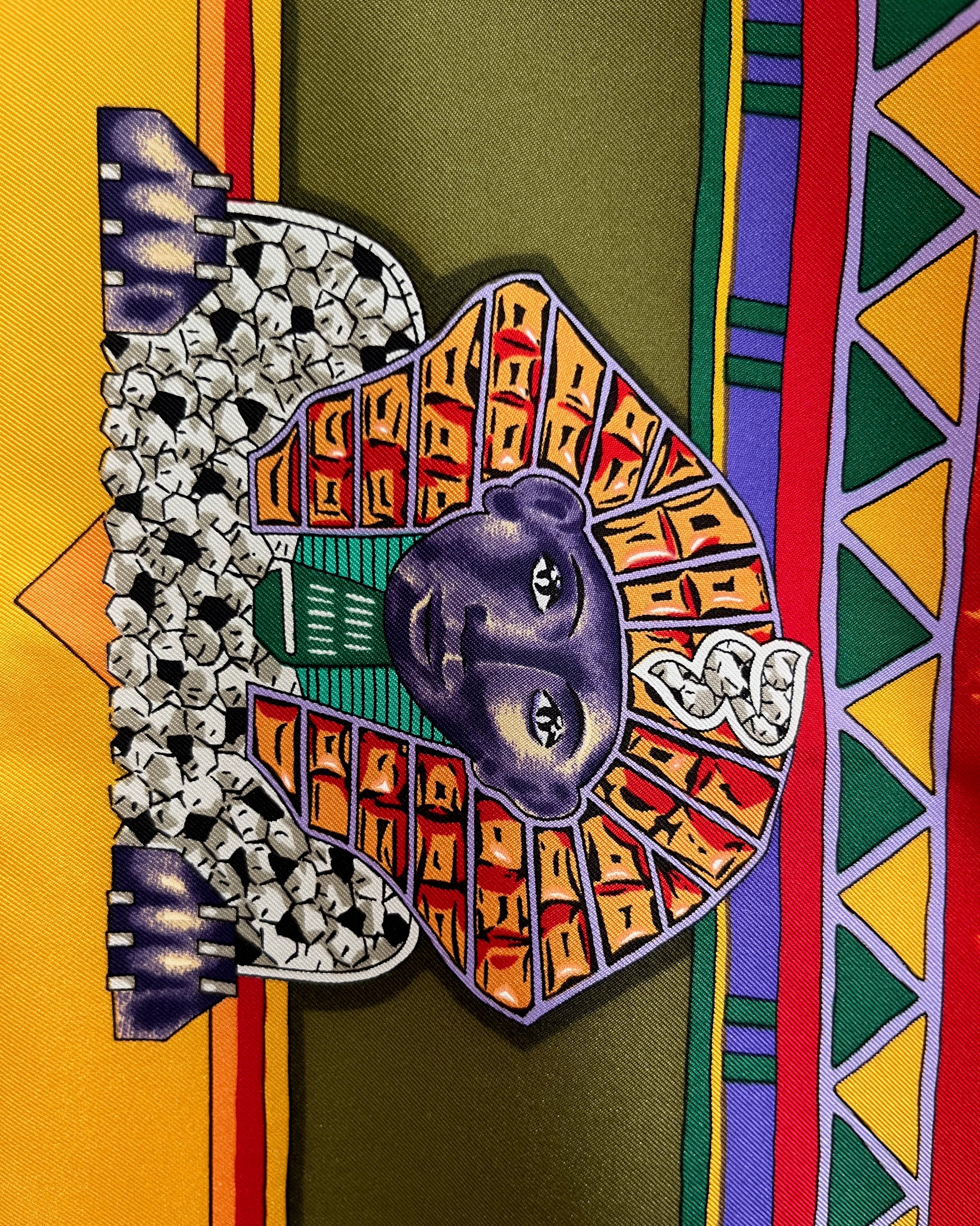 Close-up of Sphinx motif on vintage red Must de Cartier Le Scarabée silk scarf – Auric Vintage