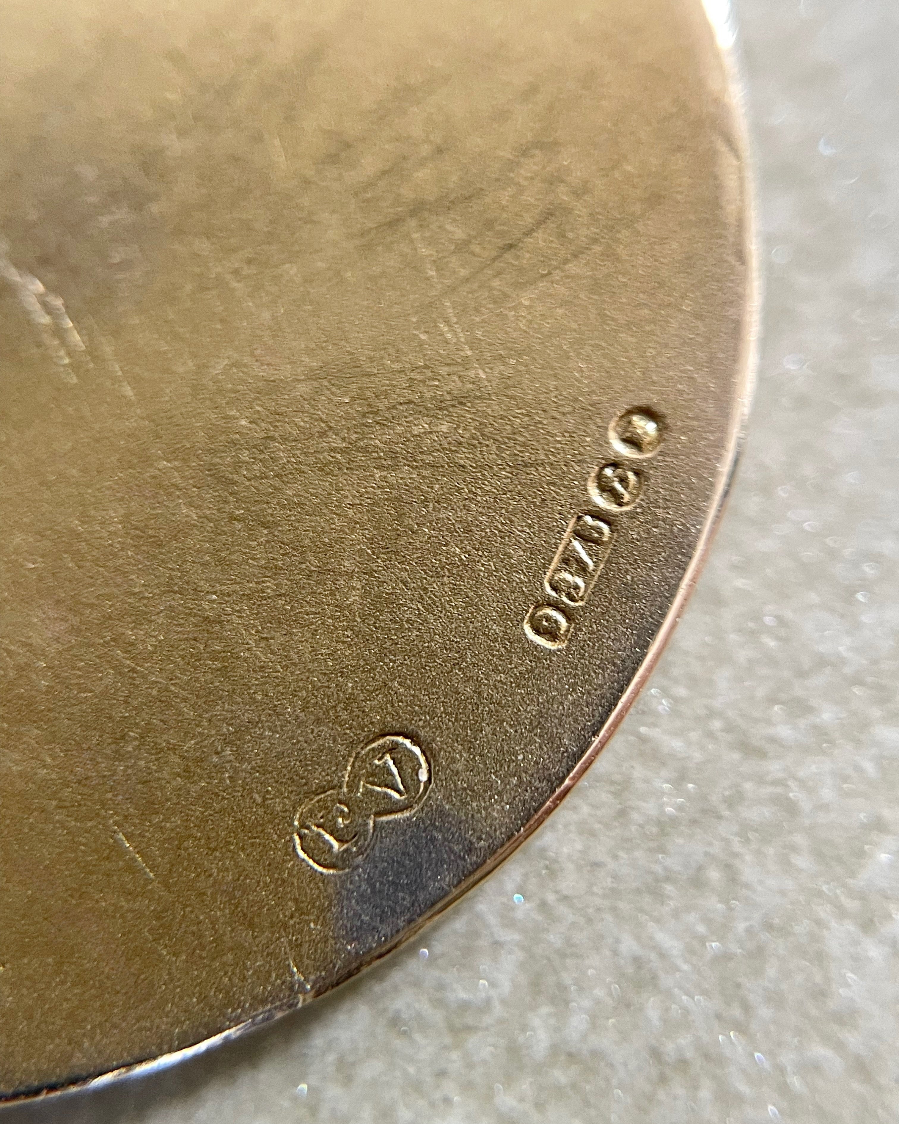 Close-up of London 1957 hallmarks on vintage Paul Vincze 9kt gold St. Christopher medal – Auric Vintage