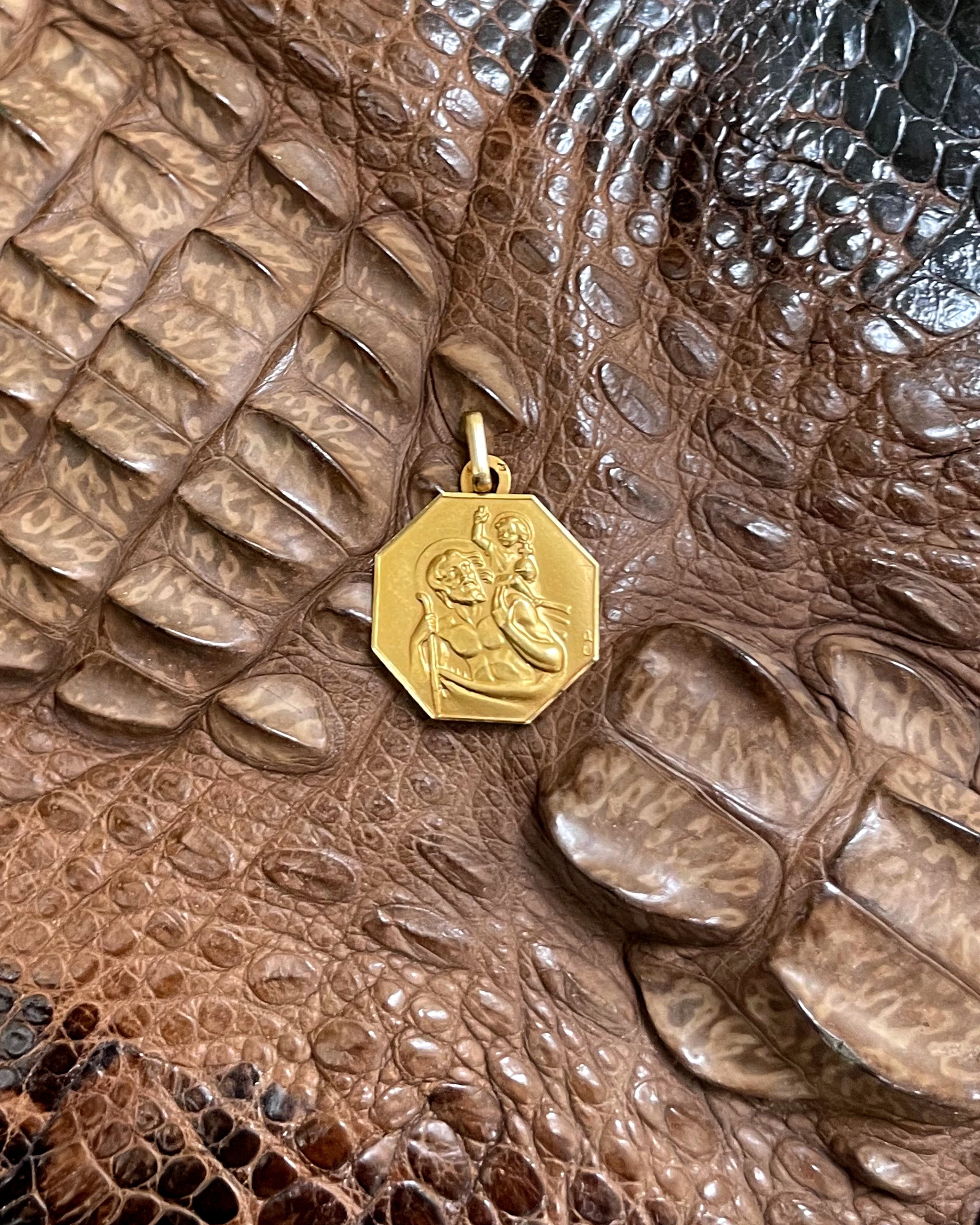 1950s French St. Christopher pendant in 18kt yellow gold displayed on crocodile skin background – Auric Vintage