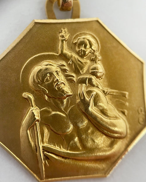 Close-up of 1950s French 18kt gold St. Christopher pendant showing Christ Child, staff and relief detail – Auric Vintage